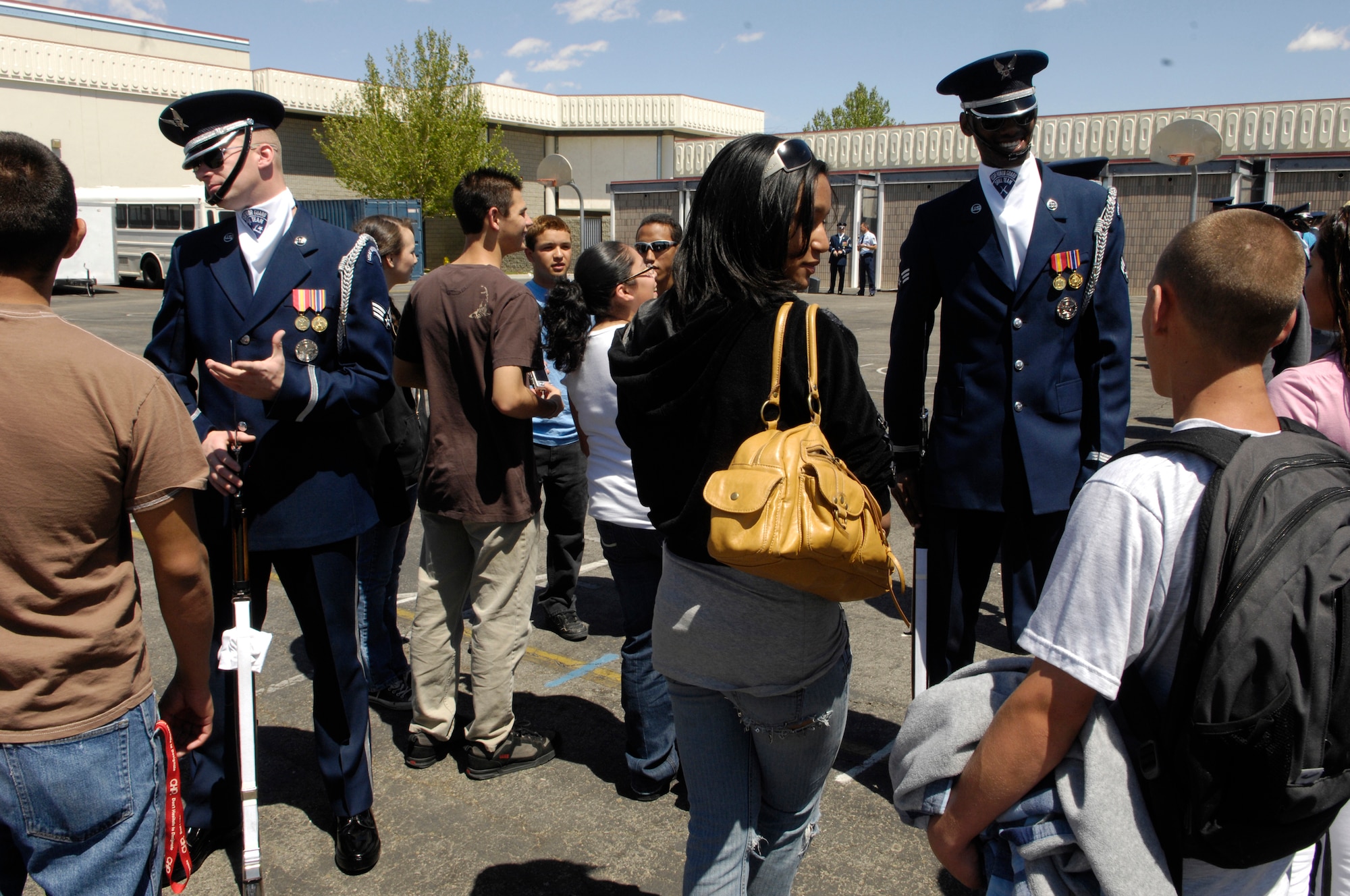 Senior Airmen Timothy Treadway and Jermaine James, Air Force Honor Guard Drill Team members, discuss Air Force opportunities and experiences with students from Lancaster HS, Calif. following their 16 Man performance during their California Tour.  The Drill Team is the traveling component of the Air Force Honor Guard and tours Air Force bases world wide showcasing the precision of today's Air Force to recruit, retain, and inspire Airmen for the Air Force mission.(U.S. Air Force photo by Senior Airman Daniel R. DeCook)(Released)