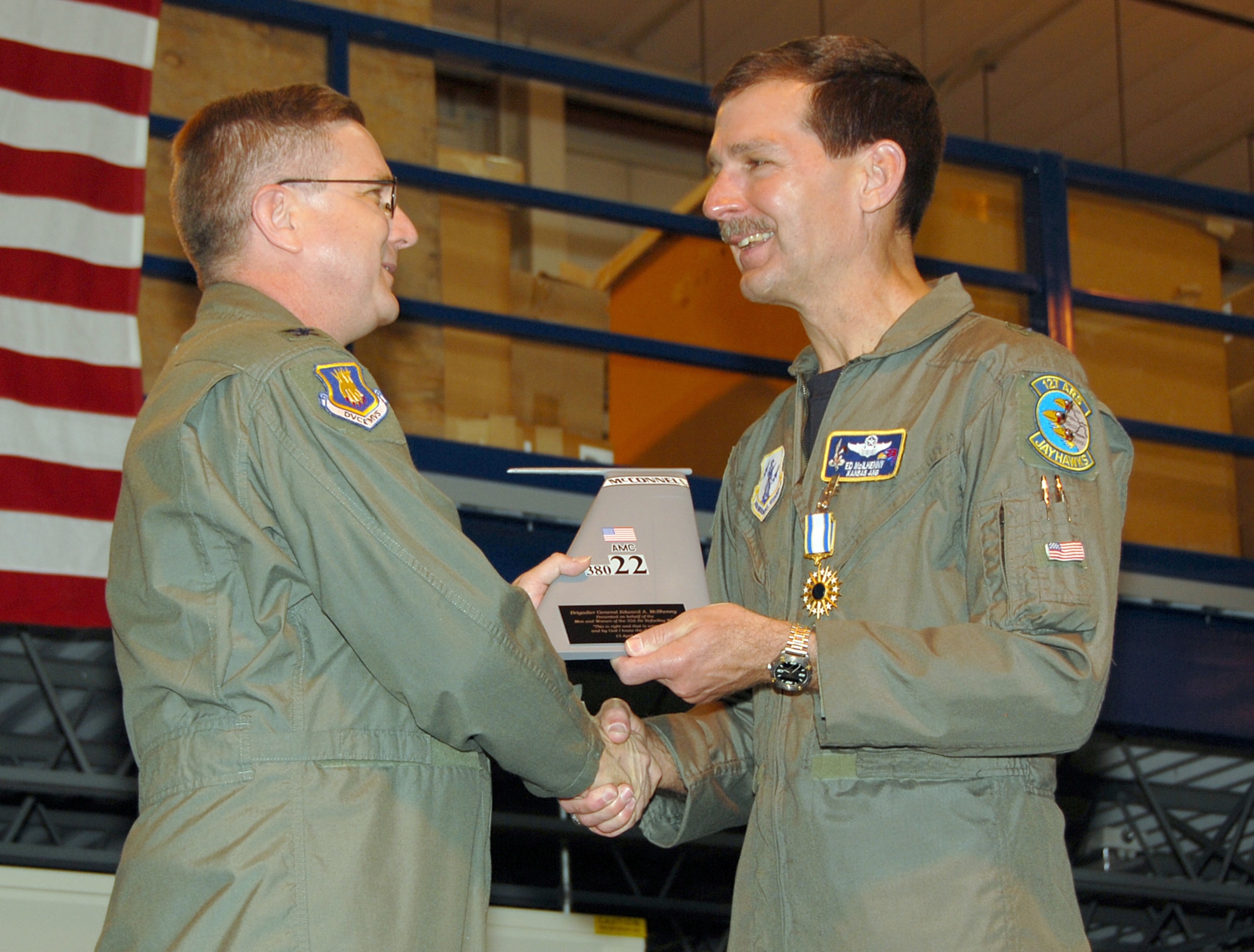 Col. Donald J. Halpin, commander of the 22nd Air Refueling Wing, presents the 22nd Tail Flash to Brig. Gen. Edward McIlhenny, April 15, during the general's retirement ceremony. General McIlhenny served as the Kansas Air National Guard assistant adjutant general for Air prior to retiring. (Photo by Senior Airman Ashley Fournier)