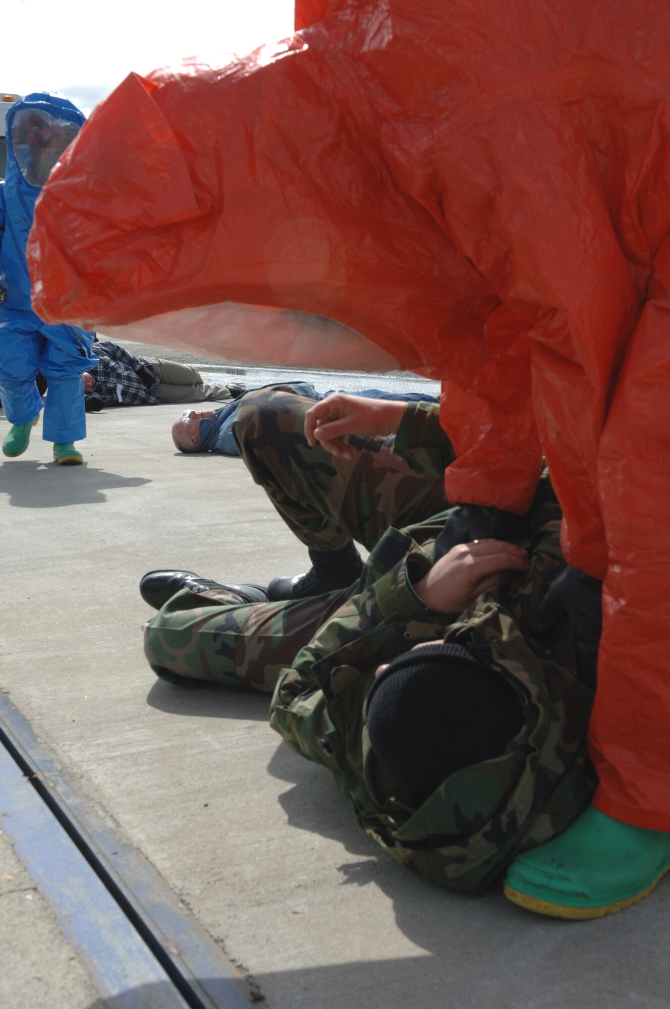 FAIRCHILD AIR FORCE BASE, Wash. -- Senior Airman Kristopher Doughty, 92nd Civil Engineer Squadron, checks on a simulated injured Airman during an exercise to test the base abilities to respond to a weapon of mass destruction here April 19. (U.S. Air Force photo/Airman 1st Class Jocelyn Ford)

