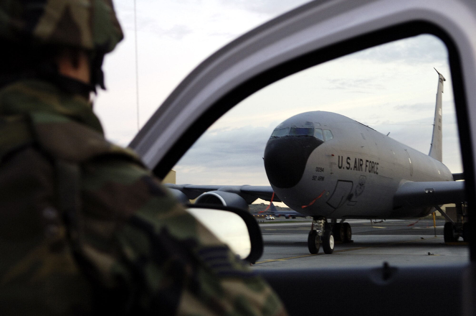 FAIRCHILD AIR FORCE BASE, Wash. -- A member of the 92nd Security Forces Squadron takes cover and provides over-watch while participating in a simulated aircraft hijacking during an exercise involving the hijacking of an aircraft on the flightline here April 18. Tech. Sgt. Joel Jones and Tech. Sgt. Cliff Spry, both of the 92nd Maintenance Group, disguised themselves as terrorists and attempted to infiltrate the flightline, taking one maintenance member hostage before being apprehended by Security Forces defenders. (U.S. Air Force photo/Senior Airman Anthony Ennamorato)