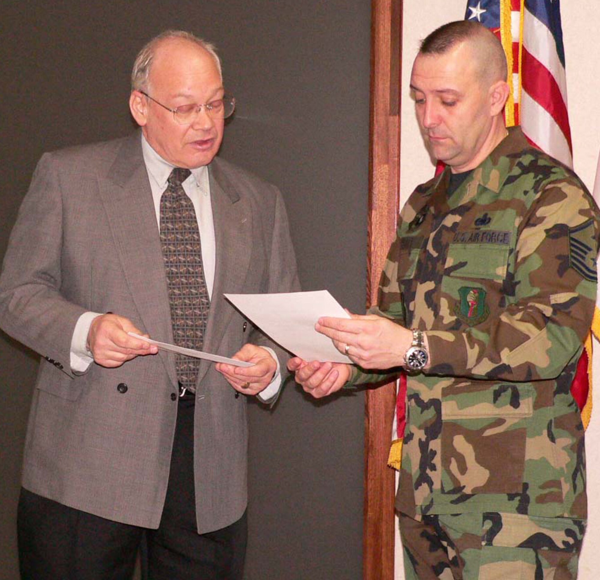 070413--MISAWA AIR BASE, Japan --  Joseph Roginski, a representative of USA Federal Credit Union, presents Master Sgt. Steven Flatt, 35th Mission Support Squadron first sergeant, with a certificate and $3,000 check for Misawa's First Sergeant Operation Warmheart fund April 13. This is the third year the Armed Forces Financial Network awarded USA Federal Credit Union an AFFN Matching Grant. AFFN's matching contribution allows USA Federal to provide the $3,000 in direct support to Misawa's Operation Warmheart.  Operation Warmheart helps Misawa Air Force families who need financial assistance. (Courtesy photo)
