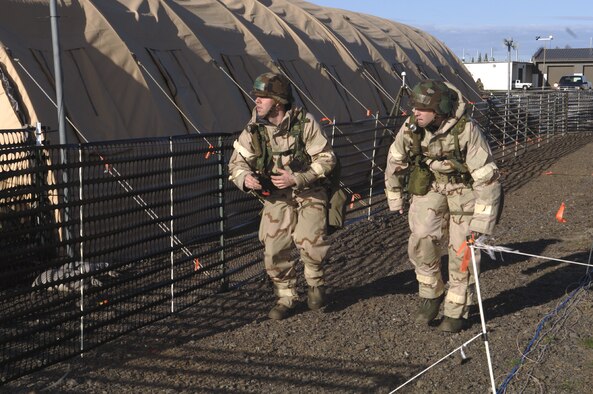 GEIGER FIELD, Wash. -- Staff Sgt. Kyle Stine (left) and Tech. Sgt. Shawn Worley (right) conducting a post-attack reconnaissance sweep during their recent Operational Readiness Inspection.