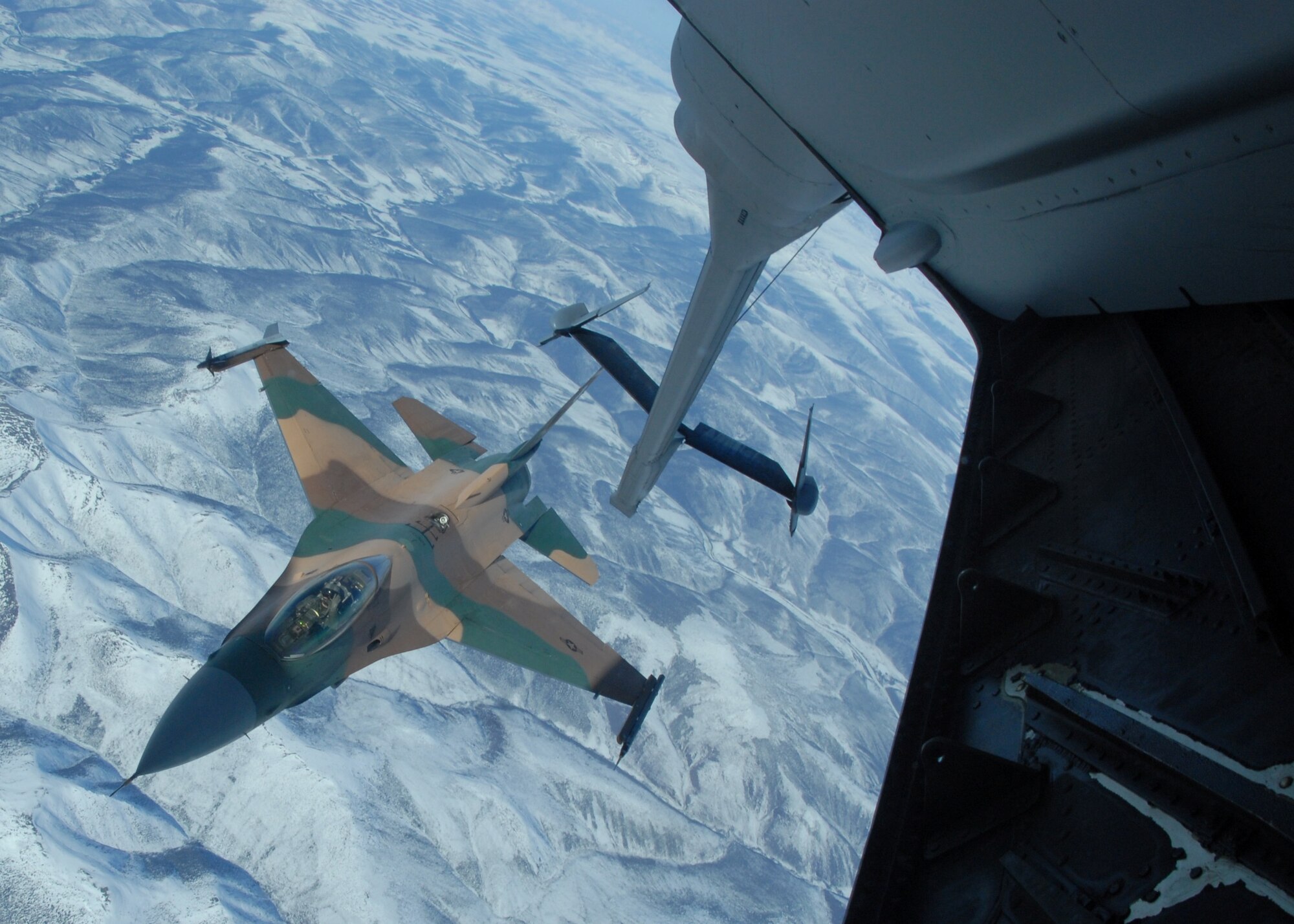 EIELSON AIR FORCE BASE, Alaska -- An F-16 Fighting Falcon, 64th Aggressor Squadron, Nellis AFB, Nev., sits in pre-contact position awaiting to receive fuel from a KC-10 extender over the Pacific Alaska Range Complex on April 18 during Red Flag-Alaska 07-1. Red Flag-Alaska is a Pacific Air Forces-directed field training exercise for U.S. forces flown under simulated air combat conditions. It is conducted on the Pacific Alaskan Range Complex with air operations flown out of Eielson and Elmendorf Air Force Bases. (U.S. Air Force Photo by Airman 1st Class Jonathan Snyder) (Released)