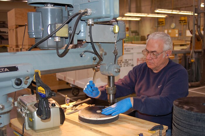 Carl Leuschner, pattern maker, drills holes into a cover for an F-15 generator. Photo by Bill Orndorff
