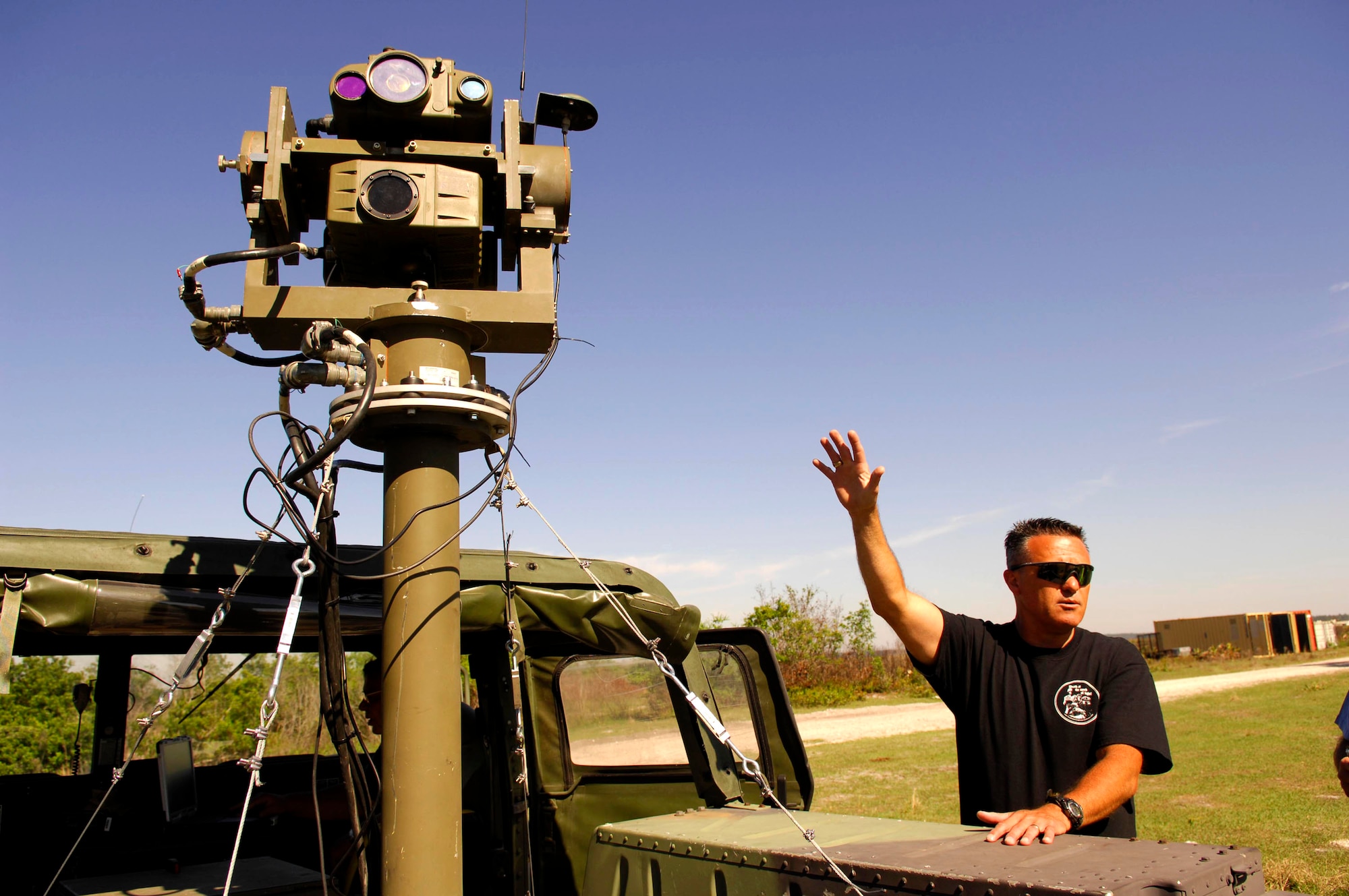 Bob Raulerson, a marketing manager from Northrop Grumman, demonstrates the capabilities of "Venom", a remote controlled lightweight laser designator rangefinder April 17 prior to using it in Atlantic Strike 5. Atlantic Strike is a joint forces training semi-annual event involving Joint Terminal Attack Controllers, or JTACs, from the Air Force, Army and Marines at Avon Park Air Ground training Complex, Avon Park, Fla.(U.S. Air Force photo/Staff Sgt. Stephen J. Otero)
