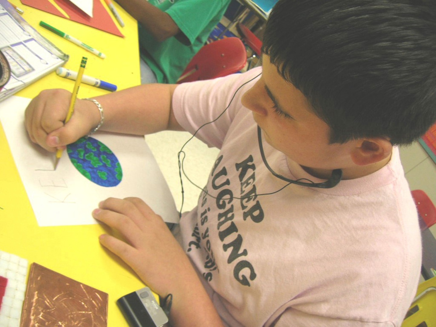 Lane Coquillette, a sixth-grader at Lackland Elementary School, Lackland Air Force Base, Texas, switches from markers to pencil for his Earth Day drawing during art class April 12. The artwork will be taped to paper grocery bags and distributed at the commissary in observance of Earth Day. Lane is the son of Melissa and Capt. Shane Banks, 59th Surgical Operations Squadron. (USAF photo by David Garcia)
