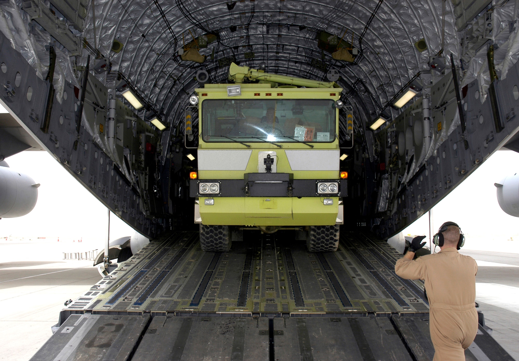 Airmen from the 386th Expeditionary Logistics Readiness Squadron load a fire and rescue truck April 19 inside a C-17 Globemaster III in Southwest Asia. The truck is one of two donated by Baltimore officials and bound for Mazar-i-Sharif Airport in Northern Afghanistan. (U.S. Air Force photo/Staff Sgt. Ian Carrier)