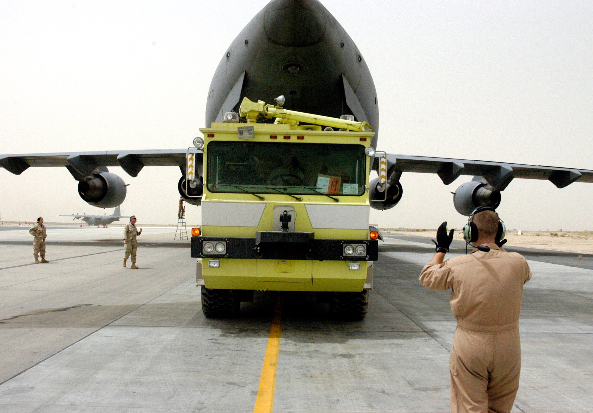 Airmen from the 386th Expeditionary Logistics Readiness Squadron load a fire and rescue truck April 19 inside a C-17 Globemaster III in Southwest Asia. The truck is one of two donated by Baltimore officials and bound for Mazar-i-Sharif Airport in Northern Afghanistan. (U.S. Air Force photo/Staff Sgt. Ian Carrier)