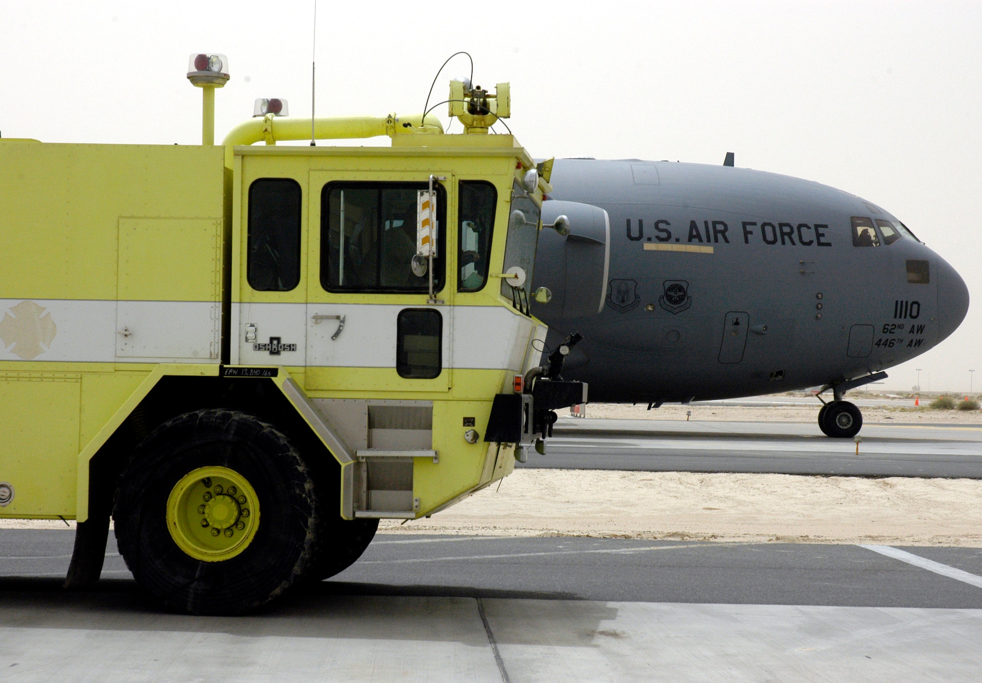 One of two fire and rescue trucks donated by Baltimore officials and bound for Mazar-i-Sharif Airport in Northern Afghanistan sits on a runway at a forward operating location in Southwest Asia April 19 awaiting to be loaded into a C-17 Globemaster III. (U.S. Air Force photo/Staff Sgt. Ian Carrier) 