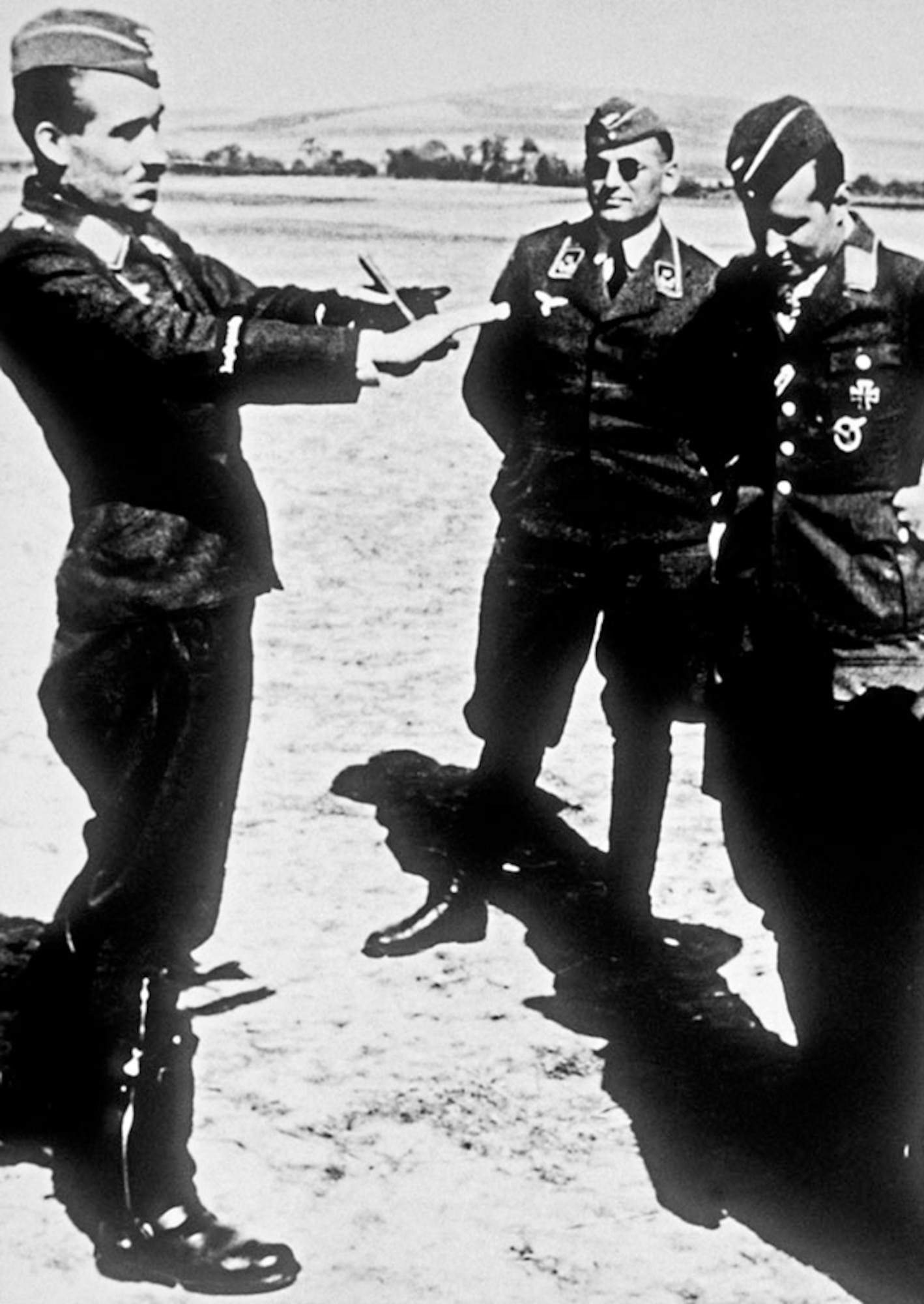 Luftwaffe General of Fighters Adolf Galland describes a dogfight to fellow pilots. (U.S. Air Force photo)