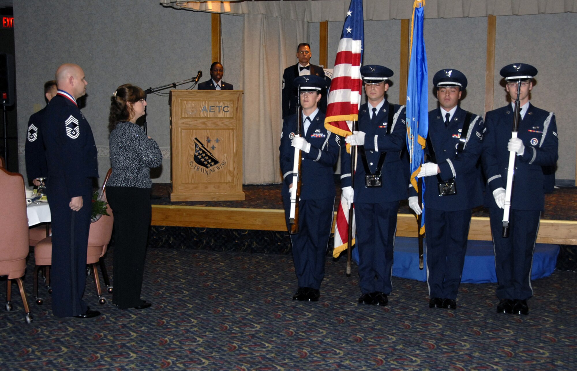 Members of the Sheppard Air Force Base honor guard present the colors during the singing of the national anthem  April 13 at the Chief Master Sergeant Recognition Ceremony, held at the Sheppard Club. (U.S. Air Force photo/Sandy Wassenmiller)