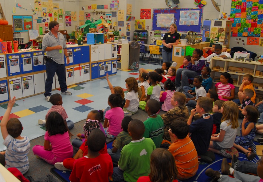 MOODY AIR FORCE BASE, Ga. -- Terry Hendricks, waste and recycling program manger for Sloan Associates Inc., speaks to children about recycling at the Moody Air Force Base Youth Center. After the presentation, the children received Earth Day 2007 T-shirts and posed for a group photo outside with the 23rd Civil Engineer Squadron's electric car. (U.S. Air Force Photo by Tech. Sgt. Parker Gyokeres)  