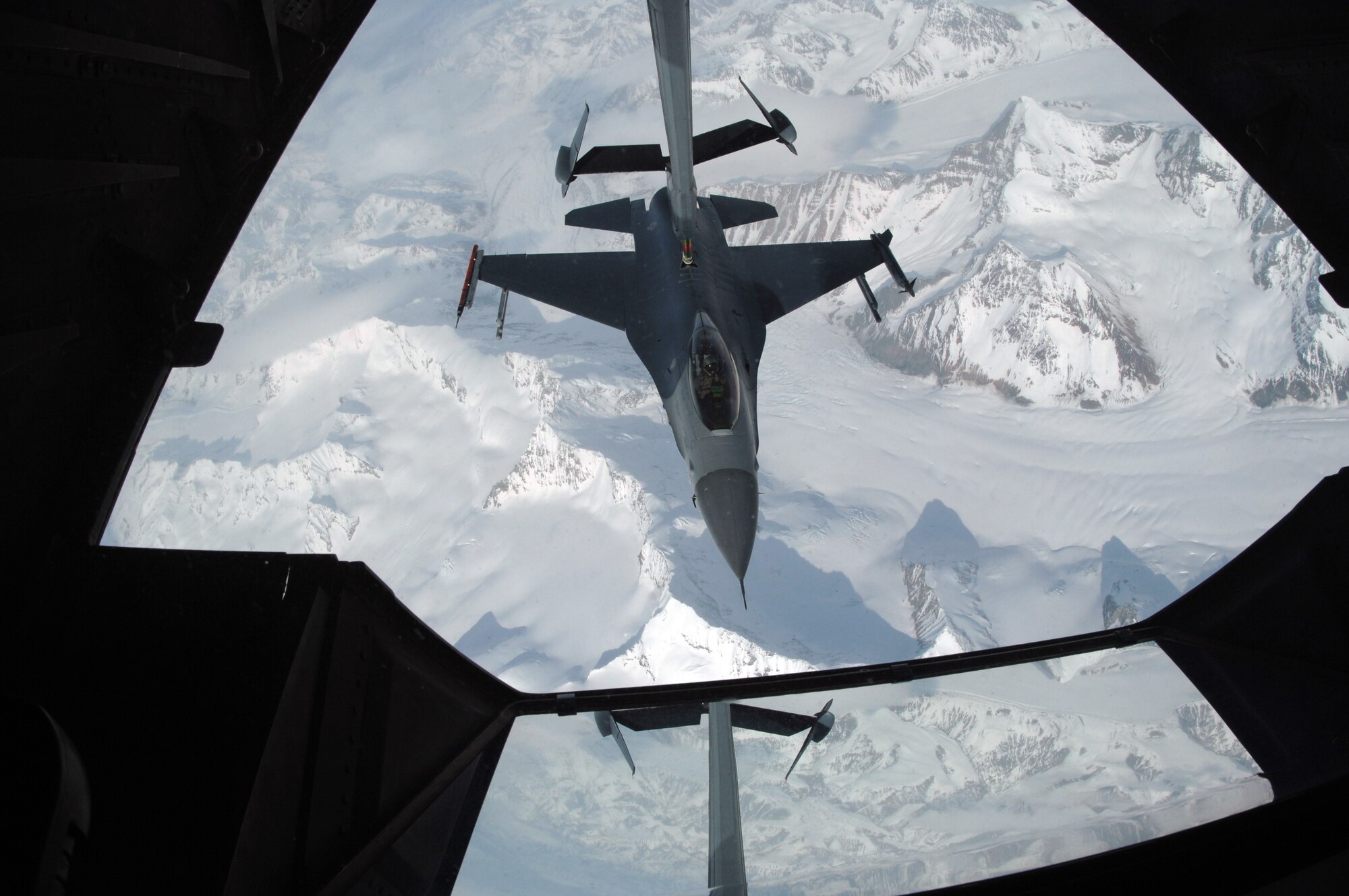 EIELSON AIR FORCE BASE, Alaska -- An F-16C, 18th Fighter Squadron, Eielson Air Force Base, Alaska, refuels from KC-10 Extender, call sign "Shaman Five One" during a refueling mission here on 18 April in support of Red Flag-Alaska 07-1. The KC-10 Extender is from McGuire Air Force Base, New Jersey and can refuel using both drouge and probe refueling in a single mission which makes it a very versitile refueling platform. Red Flag-Alaska is a Pacific Air Forces-directed field training exercise for U.S. forces flown under simulated air combat conditions. (U.S. Air Force photo by Staff Sgt. Joshua Strang)