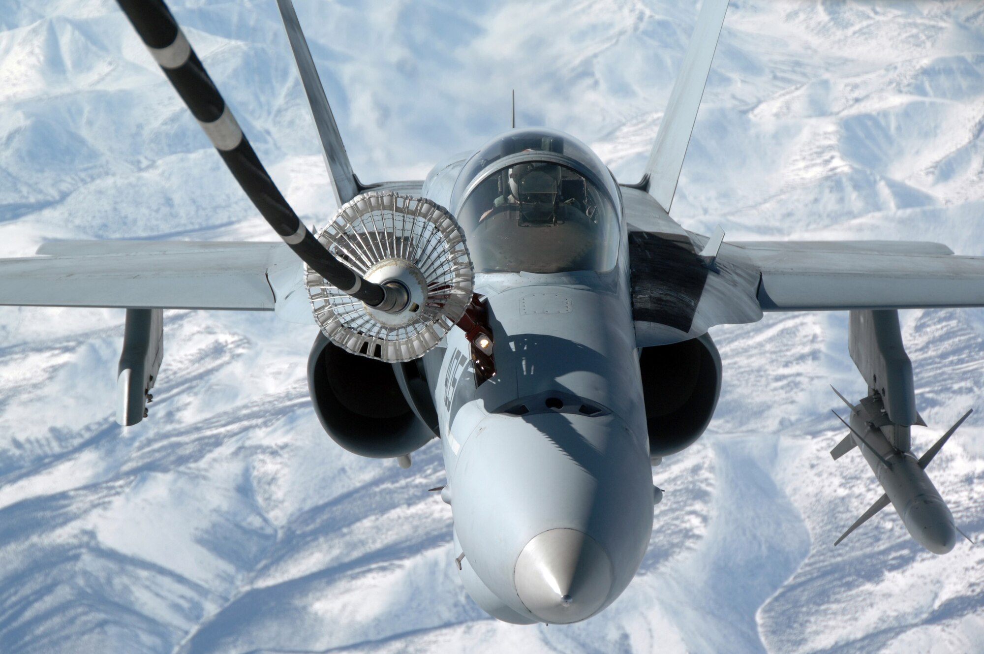 EIELSON AIR FORCE BASE, Alaska -- A Navy F/A-18 from Strike Fighter Squadron Eight Seven (VFA-87) refuels from KC-10 Extender, call sign "Shaman Five One" during a refueling mission here on 18 April in support of Red Flag-Alaska 07-1. The KC-10 Extender is from McGuire Air Force Base, New Jersey and can refuel using both drouge and probe refueling in a single mission which makes it a very versitile refueling platform. Red Flag-Alaska is a Pacific Air Forces-directed field training exercise for U.S. forces flown under simulated air combat conditions. (U.S. Air Force photo by Staff Sgt. Joshua Strang)