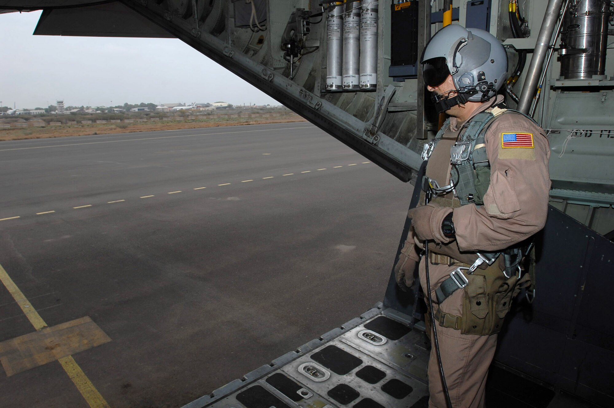 Senior Master Sgt. Karl Cdebaca looks out of the back of an HC-130 aircraft during a Combined Joint Task Force-Horn of Africa mission. Sergeant Cdebaca is deployed to Africa from the 39th Combat Rescue Squadron at Patrick Air Force Base, Fla. CJTF-Horn of Africa is a unit of United States Central Command. The organization's mission is to prevent conflict, promote regional stability and protect coalition interests in order to prevail against extremism. (U.S. Air Force photo/Tech. Sgt. Lee Harshman) 