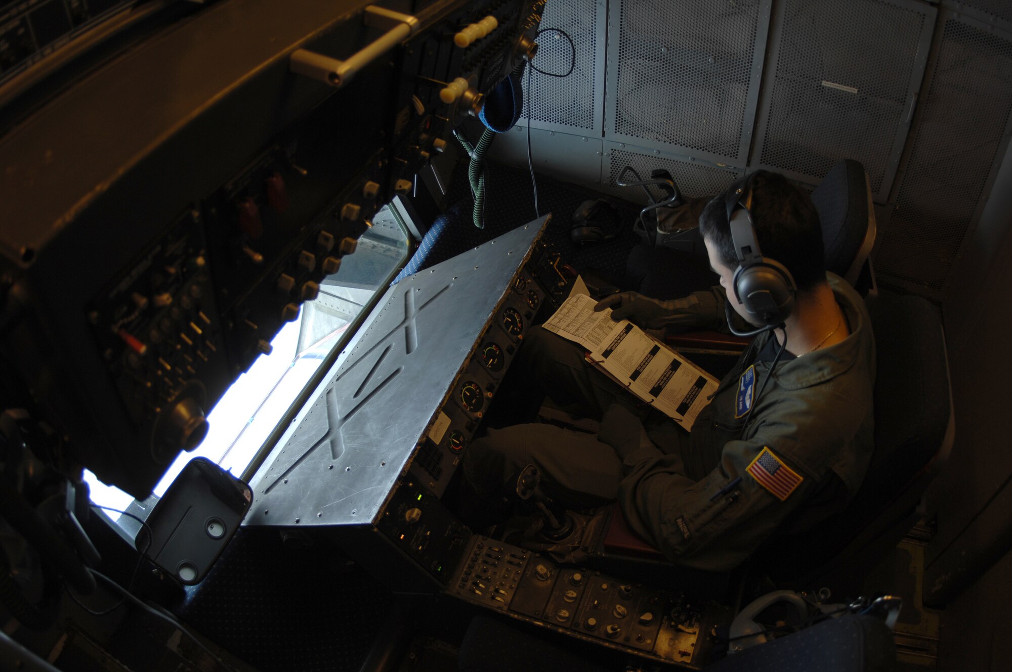 EIELSON AIR FORCE BASE, Alaska -- Staff Sgt Angel Gomez, KC-10 Boom Operator, 78th Air Refueling Squadron, McGuire Air Force Base, New Jersey checks his flight plan during a refueling mission here on 18 April in support of Red Flag-Alaska 07-1. Red Flag-Alaska is a Pacific Air Forces-directed field training exercise for U.S. forces flown under simulated air combat conditions. (U.S. Air Force photo by Staff Sgt. Joshua Strang)