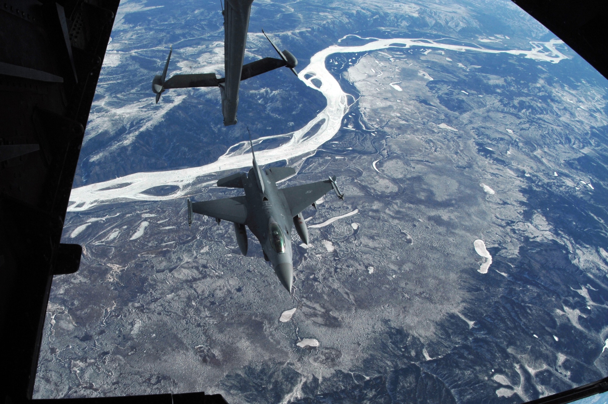 EIELSON AIR FORCE BASE, Alaska -- An F-16C, 18th Fighter Squadron "Blue Foxes", Eielson Air Force Base, Alaska, pulls away after refueling from KC-10 Extender, call sign "Shaman Five One" during a refueling mission here on 18 April in support of Red Flag-Alaska 07-1.The 18th Fighter Squadron conducts air operations for combat-ready F-16 aircraft, working closely with 355th Fighter Squadron to provide close air support, forward air control (airborne), battlefield air interdiction, and offensive counter air. Red Flag-Alaska is a Pacific Air Forces-directed field training exercise for U.S. forces flown under simulated air combat conditions. (U.S. Air Force photo by Staff Sgt. Joshua Strang)