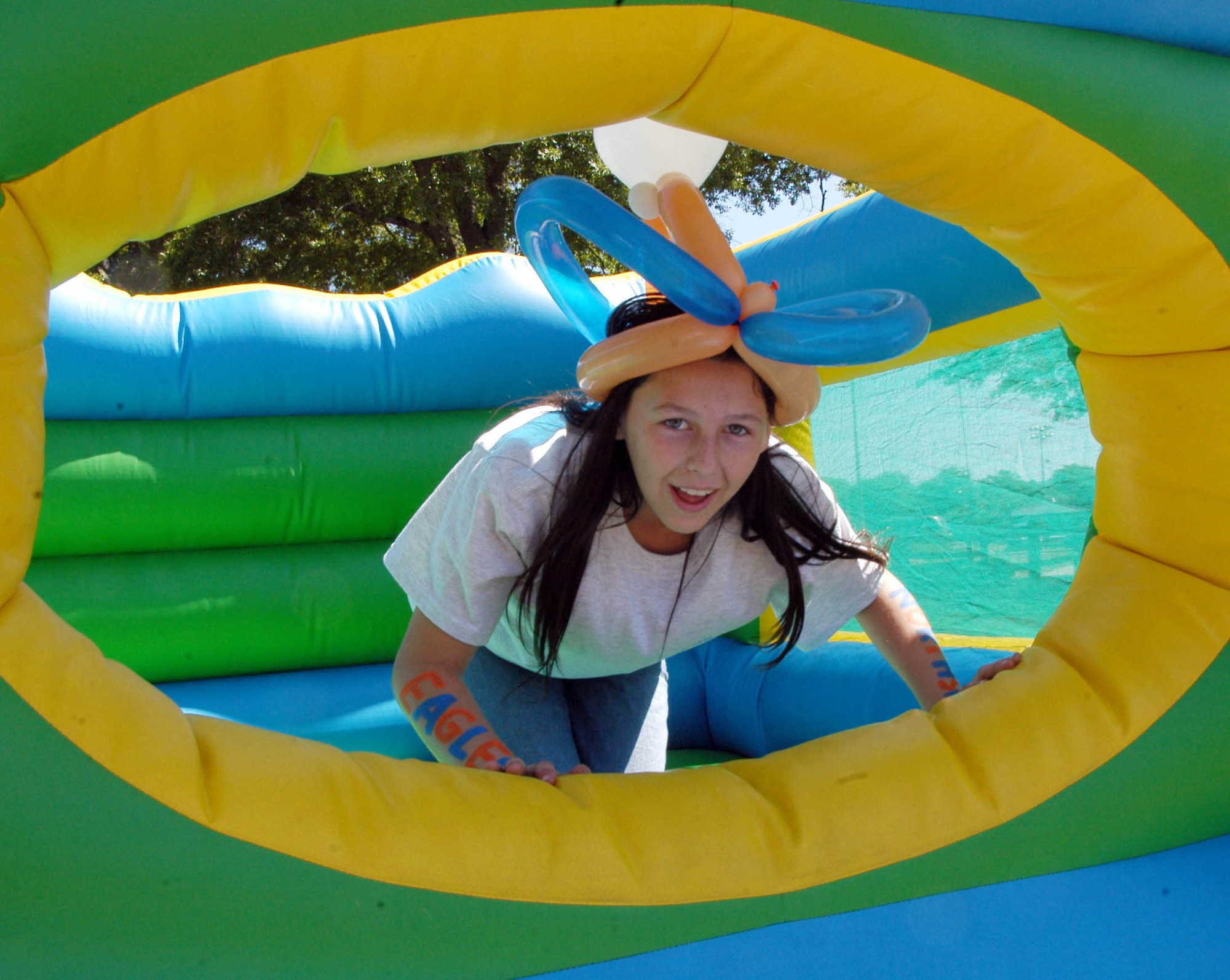 Elizabeth Phillips, 12, from Parkwood Elementary enjoyed the inflatable games. She said her mentor, Carrie Franklin, found the slide to be "scary". U. S. Air Force photo by Sue Sapp  