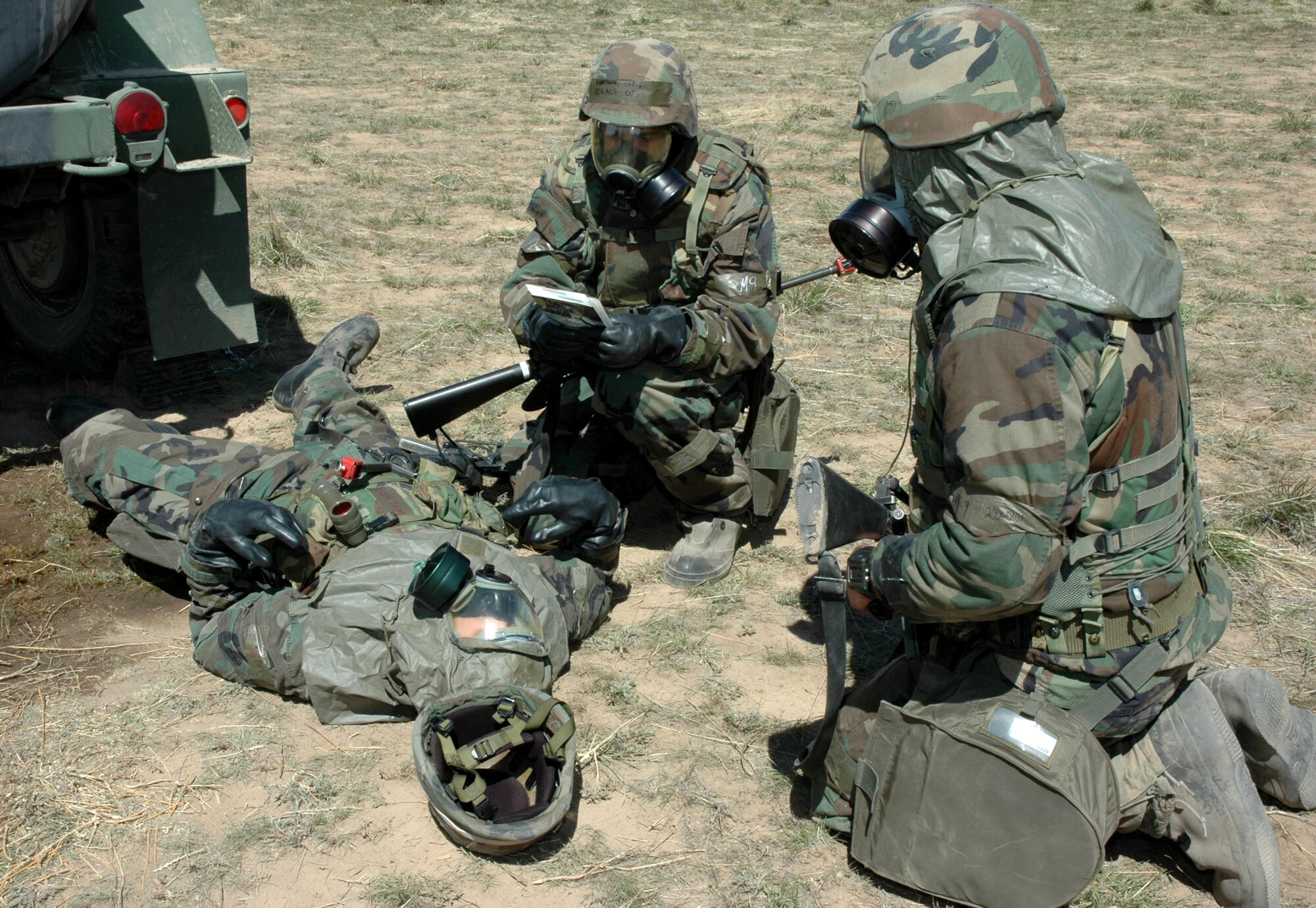MOUNTAIN HOME AIR FORCE BASE, Idaho -- Airmen from the 726th Air Control Squadron here show off their self aid and buddy care skills April 16 during a simulated injury to a fellow troop at Saylor Creek Bombing Range during a week-long deployment exercise.  Air Force photo by Airman Samantha S. DeVries