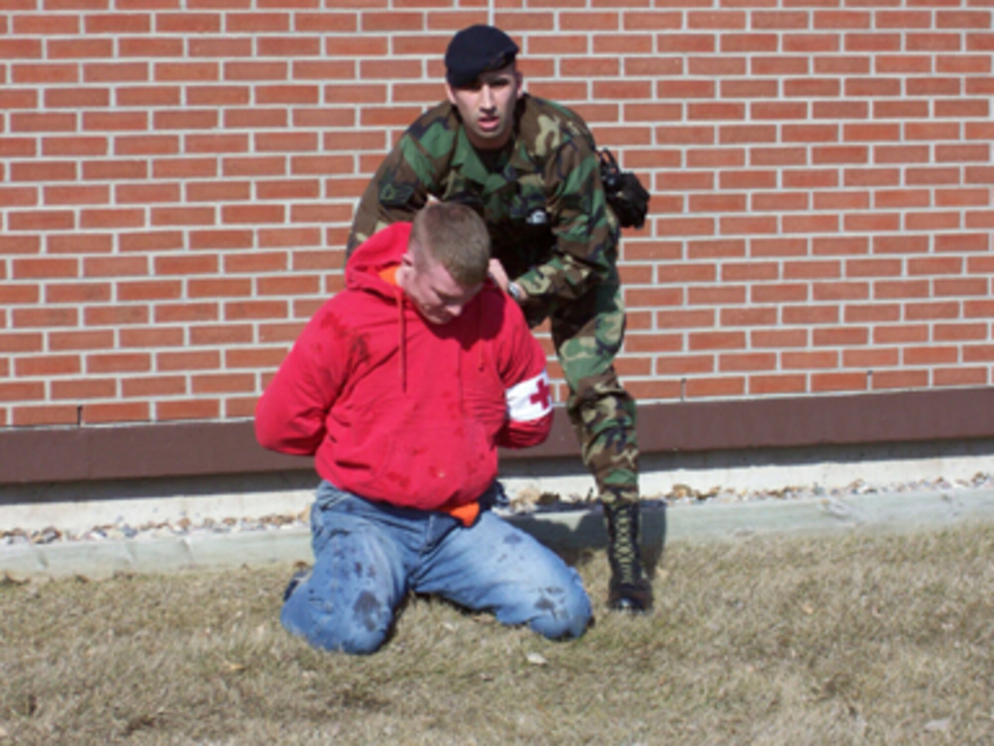 Staff Sgt. Michael Christiansen, 319th Security Forces Squadron, apprehends Staff Sgt. Daniel Mueller, 319th Aeromedical Dental Squadron, who played a child abductor during an exercise at the Medical Group facility April 12. The “Code Pink” (child abduction) exercise allowed Medical Group and Security Forces Squadron members to practice their emergency response to ensure both units respond and interact with state and local agencies. (U.S. Air Force photo/Tech. Sgt. Heather Tevebaugh)