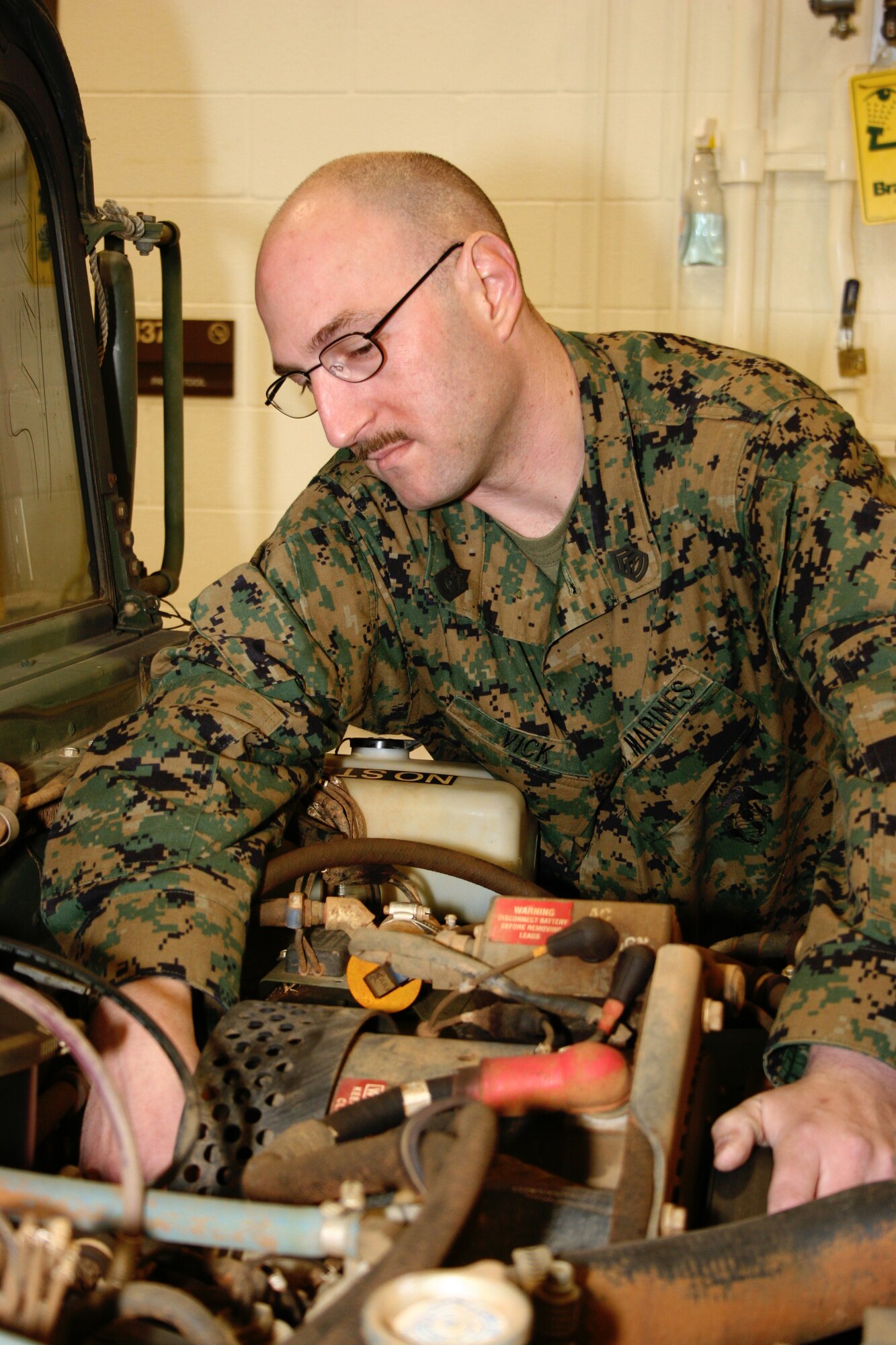 GRISSOM AIR RESERVE BASE, Ind.-- Gunnery Sgt. Jason Vick, a Motor Maintenance Chief at DET1, Communications Company, Headquarters and Service Battalion, 4th Marine Logistics Group, performs a routine inspection on a vehicle used for Marine driver's training at Grissom Air Reserve Base, Ind. Grissom Air Reserve Base is home to the Marine Corps Reserve as well as other services.(U.S. Air Force photo/Senior Airman Omar Delacruz)