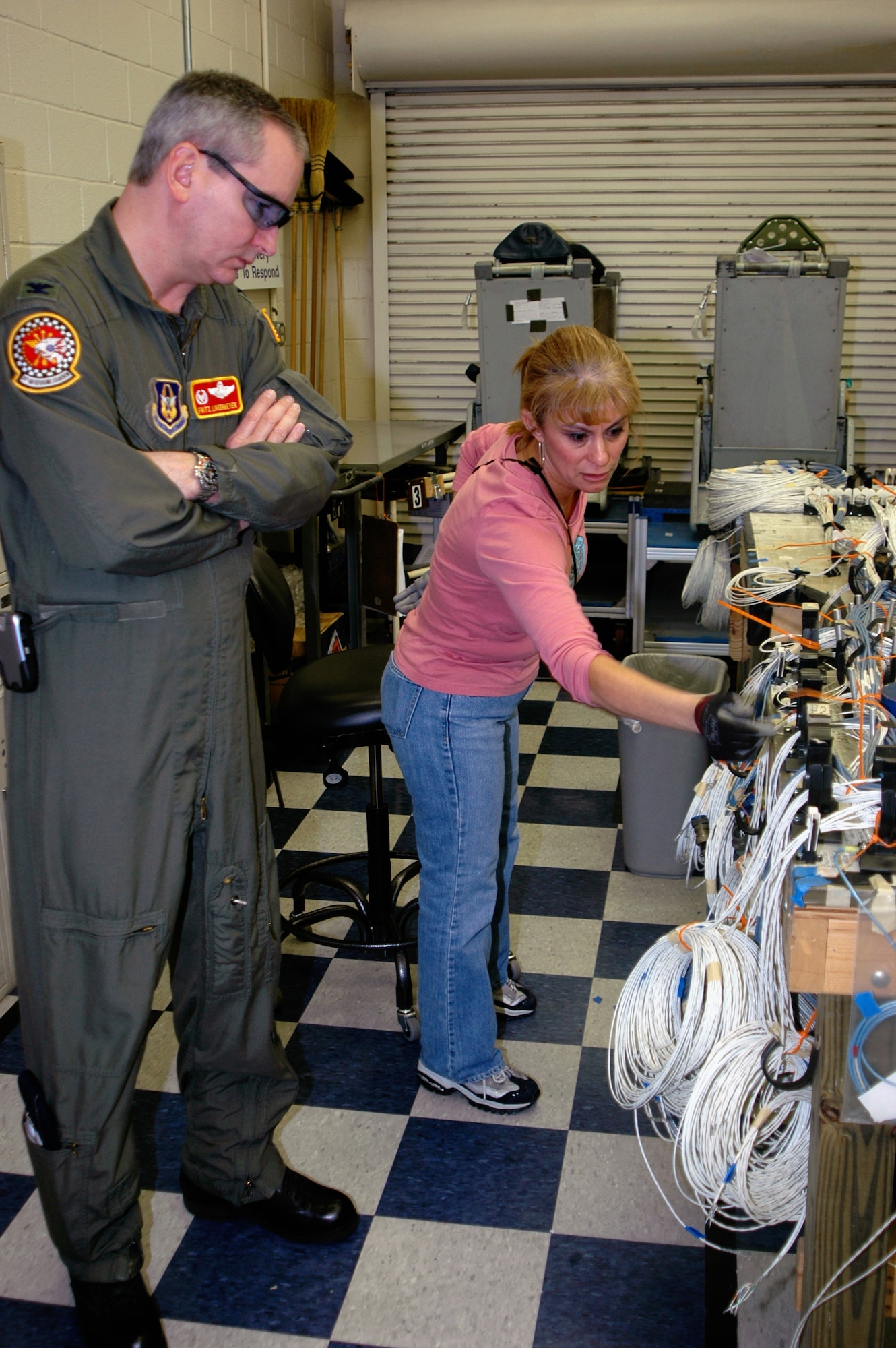 GRISSOM AIR RESERVE BASE, Ind., -- Linda Martinez, a Boeing electrical technician at Kelly Field Annex Texas, demonstrates to Col. Fritz Linsenmeyer, the 434th Operations Group commander, how the wiring harness for the KC-135 Block 40 upgrade is assembled. 