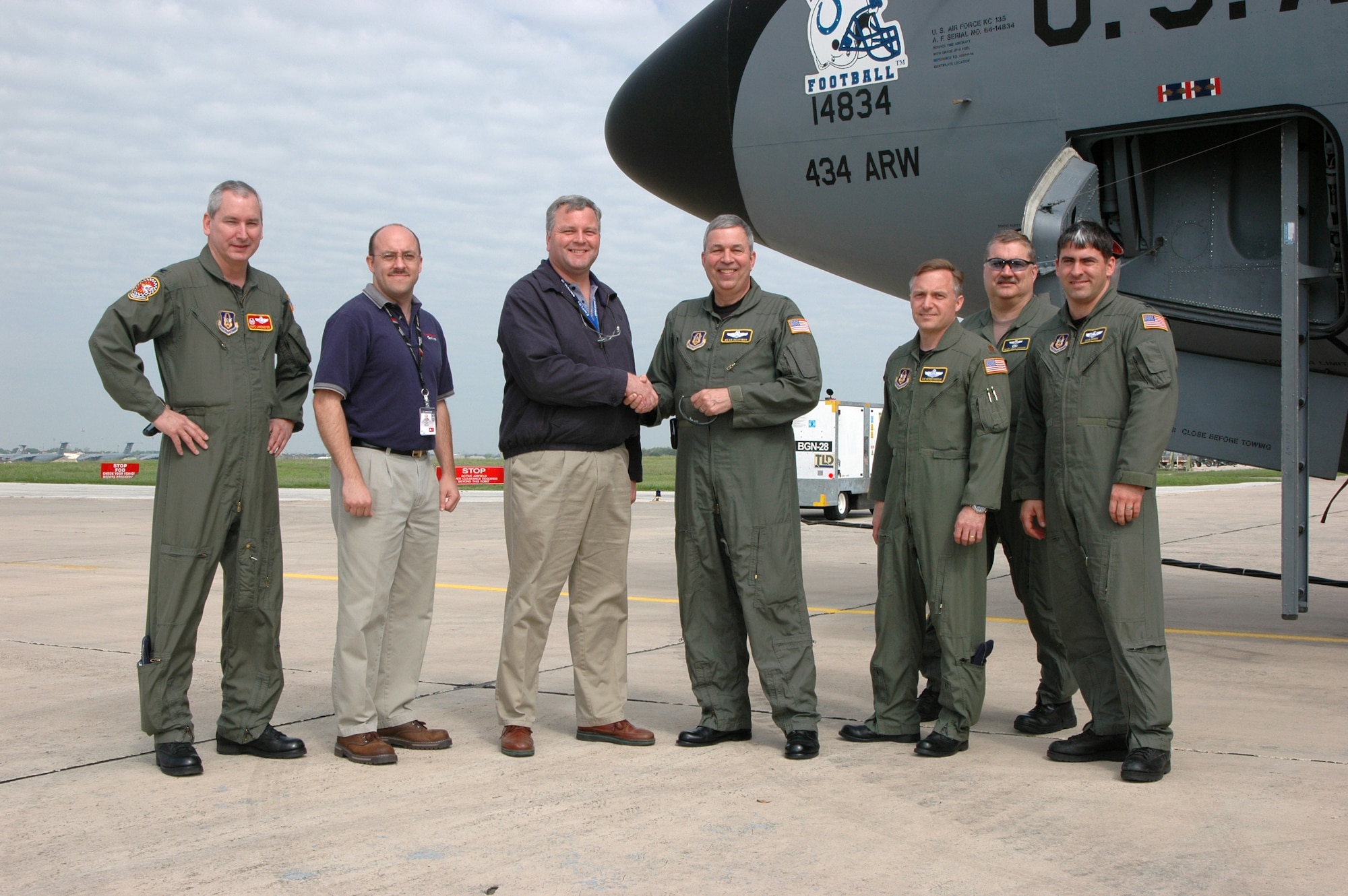 GRISSOM AIR RESERVE BASE, Ind., -- Brig. Gen. Dean Despinoy, 434th Air Refueling Wing commander, shakes hands with Steven Stiger, a Boeing staff member, during the acceptance of Grissom's first Block 40 upgraded KC-135R Stratotanker at Kelly Filed Annex, San Antonio, Texas. From the left are Trent Martin, the production support manager for Rockwell, Col. Fritz Lensemeyer, the 434th Operations Group commander, Mr. Stiger, General Despinoy, Maj. Victor Verboncoeur, a pilot with the 434th ARW, Senior Master Sgt. Paul Houser, a boom operator with the 434th Operations Support Squadron and Capt. Douglas Perry, a pilot with the 434th ARW.  (Air Force photo / SrA. Ben Mota)