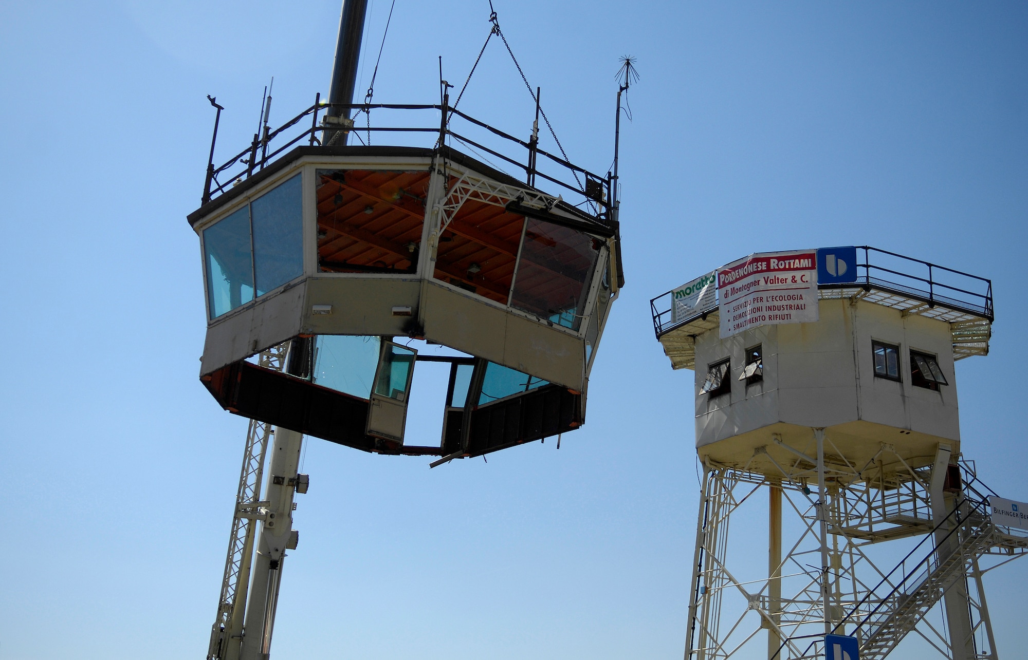 With a large crane, contractors remove the nearly 6.5 ton cap off of the old air traffic control tower. Contractors began disassembling the 43 year-old tower Tuesday. Photo by Airman 1st Class Michael Dorus