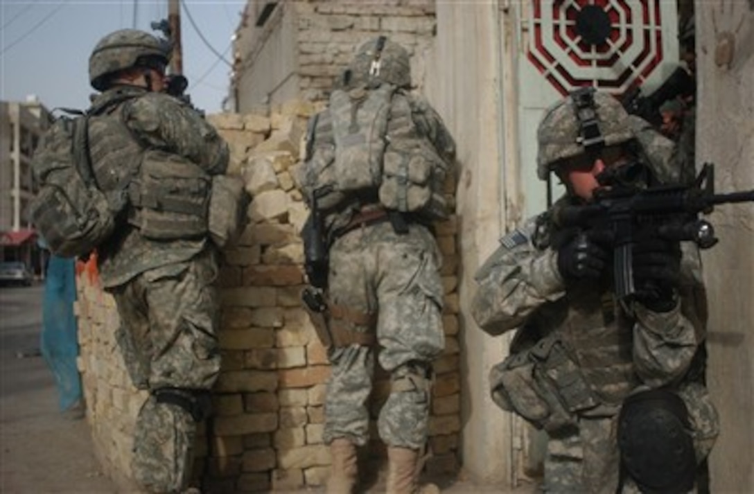 U.S. Army Staff Sgt. Rick Hamblin (right) provides rear security during a dismounted patrol in Adhamiya, Iraq, on April 6, 2007.  Hamblin is with Charlie Company, 1st Battalion, 26th Infantry Regiment, 1st Infantry Division.  