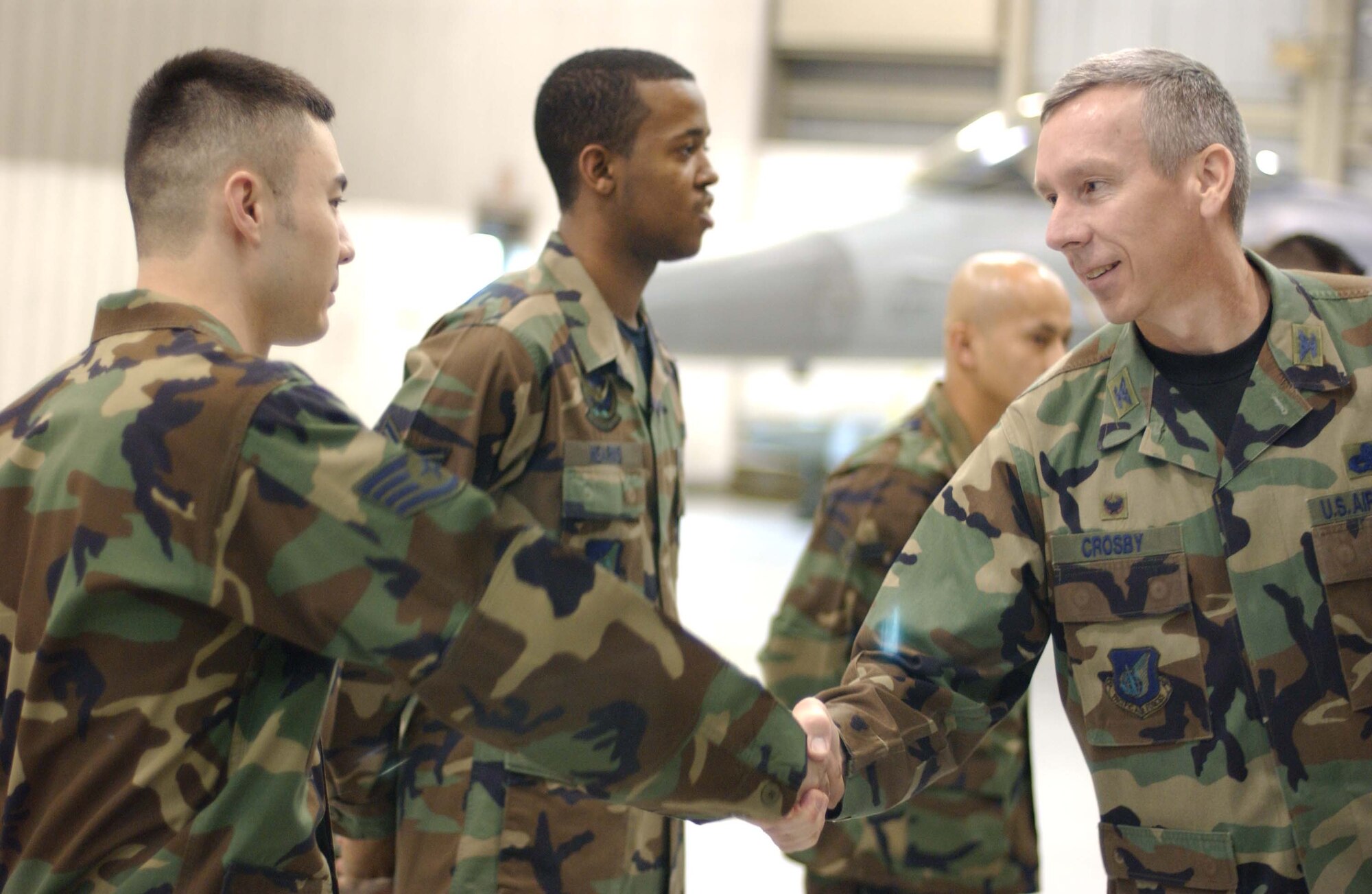 EIELSON AIR FORCE BASE, Alaska -- Colonel Ronald Crosby, 354th Maintenance Group Commander, congratulates Staff Sgt. Mike Mueller, 355th Aircraft Maintenance Unit, 354th Aircraft Maintenance Squadron, after winning the Weapons Standardization Load Crew of the Quarter Competition on April 20. The Competition evaluates technical proficiency, safety procedures and overall time. The 355th AMU's overall time was 15 minutes. (U.S. Air Force Photo by Airman Jonathan Snyder) 
