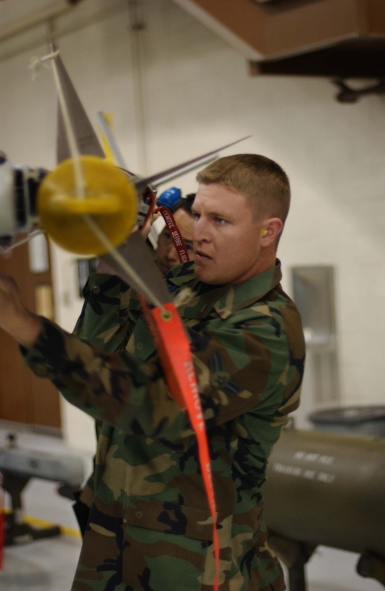 EIELSON AIR FORCE BASE, Alaska -- Airman 1st Class Jeremy Woods, 18th Aircraft Maintenance Unit, 354th Aircraft Maintenance Squadron, finishes loading an AIM-9 Sidewinder Missile during Weapons Standardization Load Crew of the Quarter Competition on April 20. The Competition evaluates technical proficiency, safety procedures and overall time. The 18th AMU's overall time was 16 minutes. (U.S. Air Force Photo by Airman Jonathan Snyder) 
