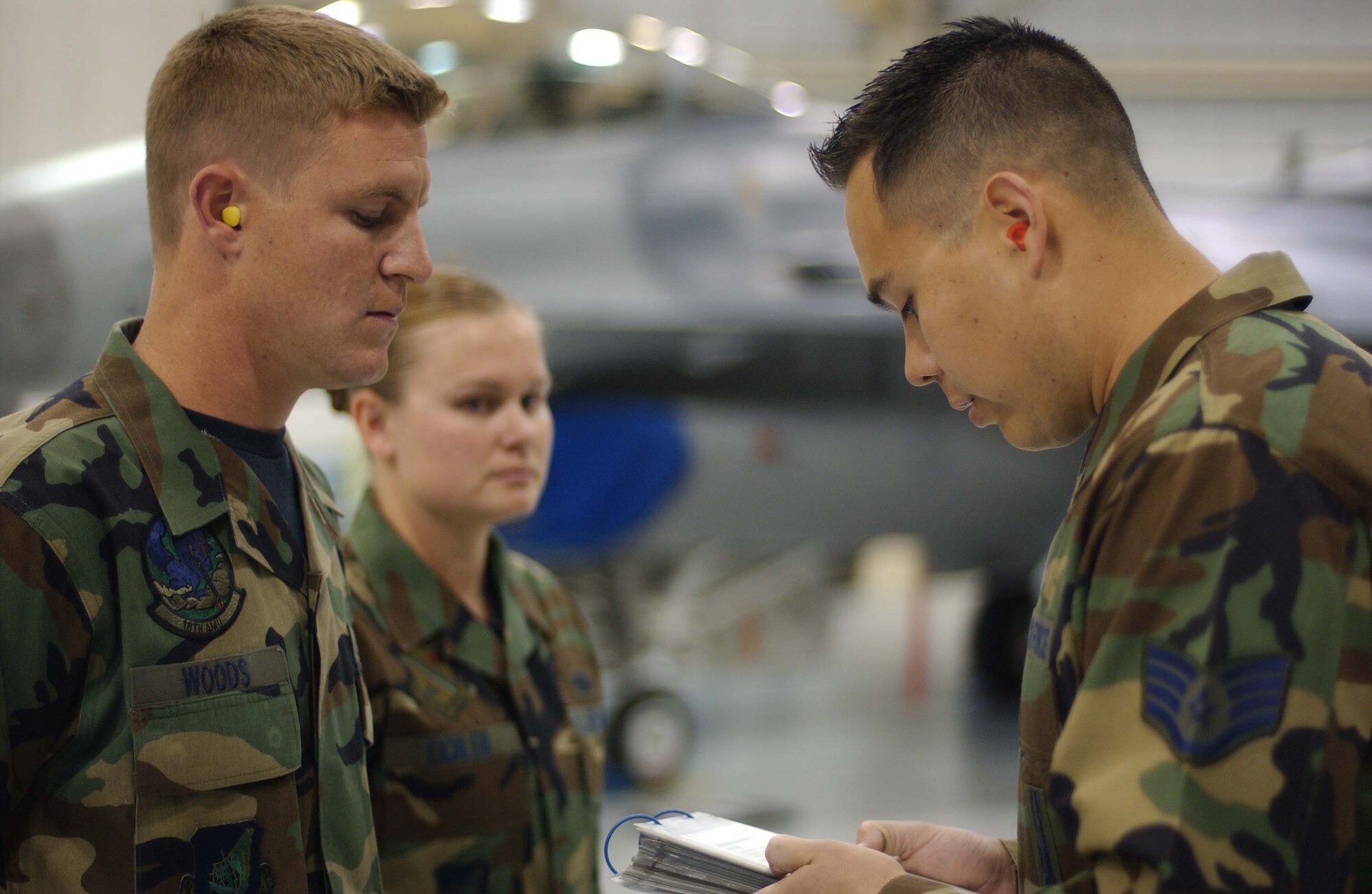 EIELSON AIR FORCE BASE, Alaska -- Staff Sgt. Manuel Sanchez (Right) goes over safety instructions to Airman 1st Class Jeremy Woods (Left) and Senior Airman Shasta Eichler (Back) prior to the Weapons Standardization Load Crew of the Quarter Competition on April 20. The Competition evaluates technical proficiency, safety procedures and overall time. The 18th AMU's overall time was 16 minutes. (U.S. Air Force Photo by Airman Jonathan Snyder) 