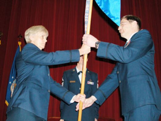 Col. Pamela LeBlanc, 452nd Mission Support Group commander at March Air Reserve Base, left, accepts the guidon from incoming 50th Aerial Port Squadron commander, Major Jody W. Chalich, on April 15.  Major Mary Van Scyoc, outgoing commander of the 50th APS, delivered her goodby to the audience at the change of command ceremony. (U.S. Air Force photo by Tech. Sgt. Michael Blair, 452 AMW)