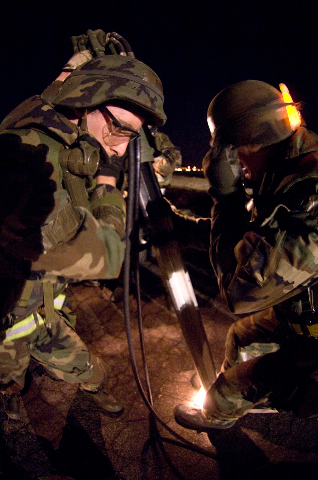 Members of the 8th Civil Engineer Squadron Airfield Damage Repair team install anchors in the Mobile Aircraft Arresting System April 19 at Kunsan Air Base, South Korea. The MAAS contains the cable used to stop damaged aircraft that cannot stop on their own during landing. Kunsan AB is currently undergoing an Operational Readiness Inspection to test the 8th Fighter Wing's ability to conduct its wartime mission. During exercises, ADR teams perform several functions including crater repair after simulated attacks and airfield lighting during simulated power outages, making it possible to get aircraft back in the air quickly. (U.S. Air Force photo/Master Sgt Jack Braden)