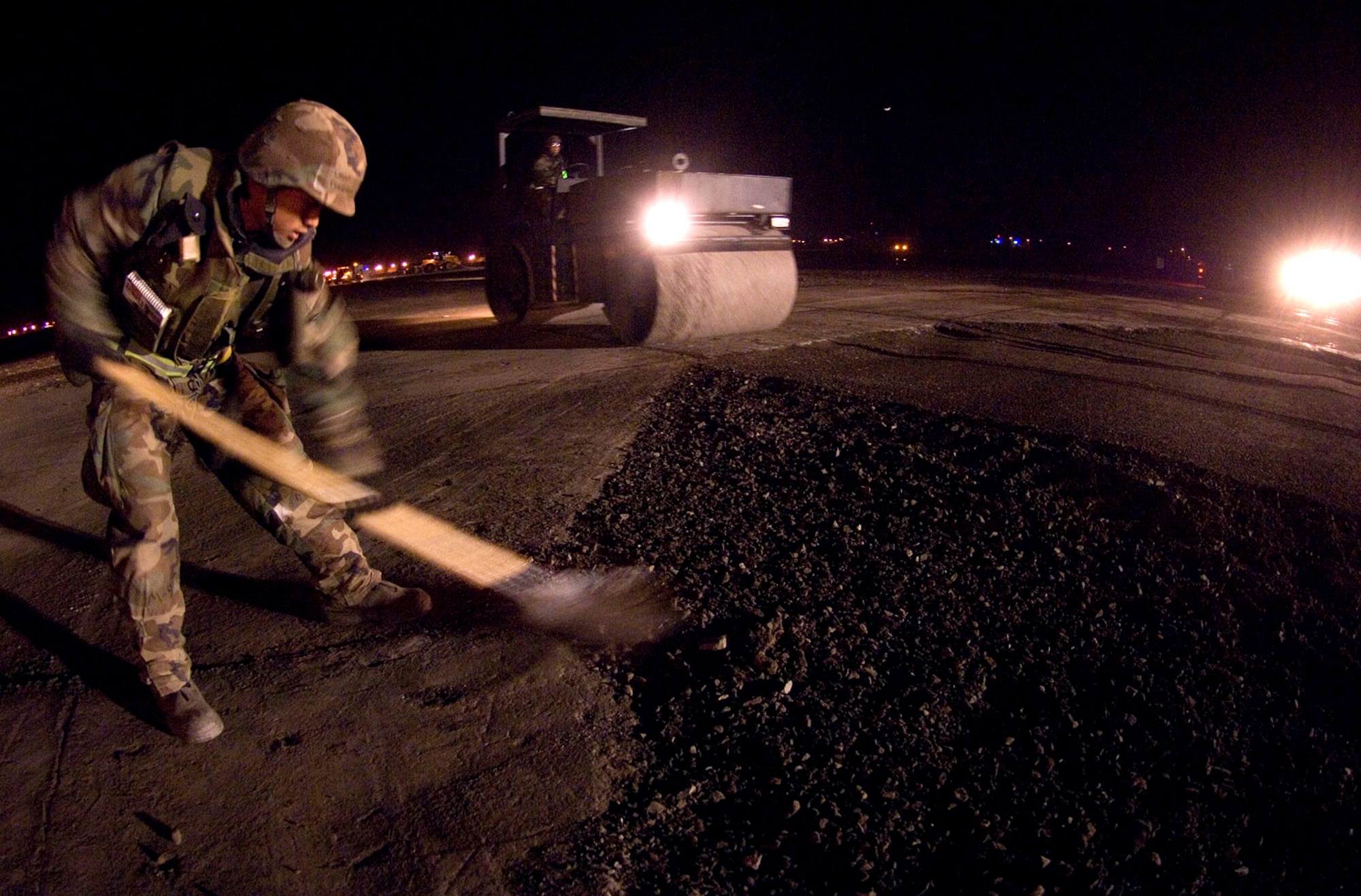 Staff Sgt Ephraim Advincula, an 8th Civil Engineer Squadron Airfield Damage Repair team member, shovels gravel into a crater being repaired on the runway April 19 at Kunsan Air Base, South Korea. Kunsan AB is currently undergoing an Operational Readiness Inspection to test the 8th Fighter Wing's ability to conduct its wartime mission. During exercises, ADR teams perform several functions including crater repair after simulated attacks and airfield lighting during simulated power outages, making it possible to get aircraft back in the air quickly. (U.S. Air Force photo/Master Sgt Jack Braden)
