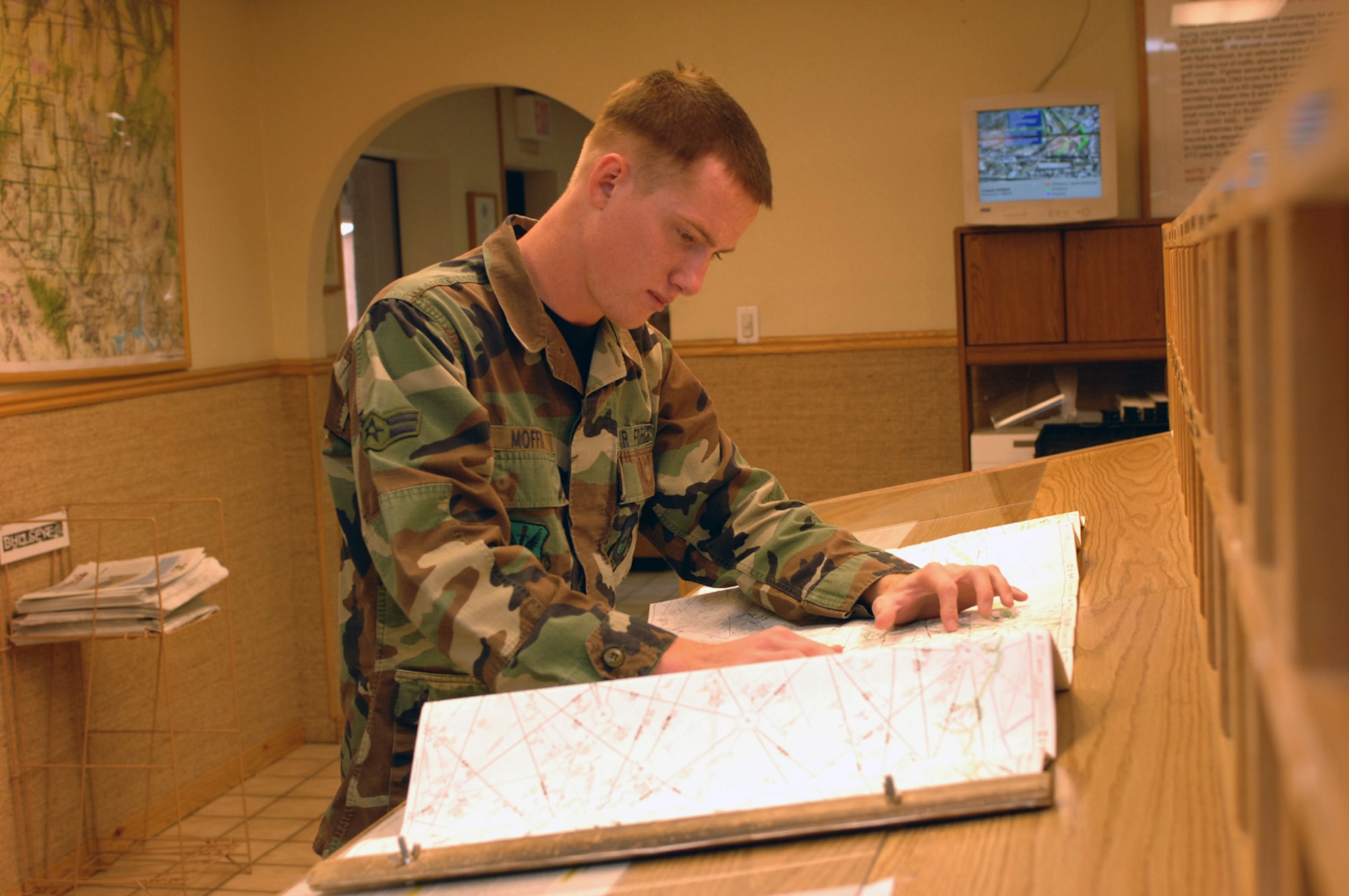 Airman 1st Class Sean Moffit, 57th Operations Support Squadron, Airfield Management, looks at the map to verify the route of the flight. (U.S. Air Force Photo by Senior Airman Jason Huddleston)
