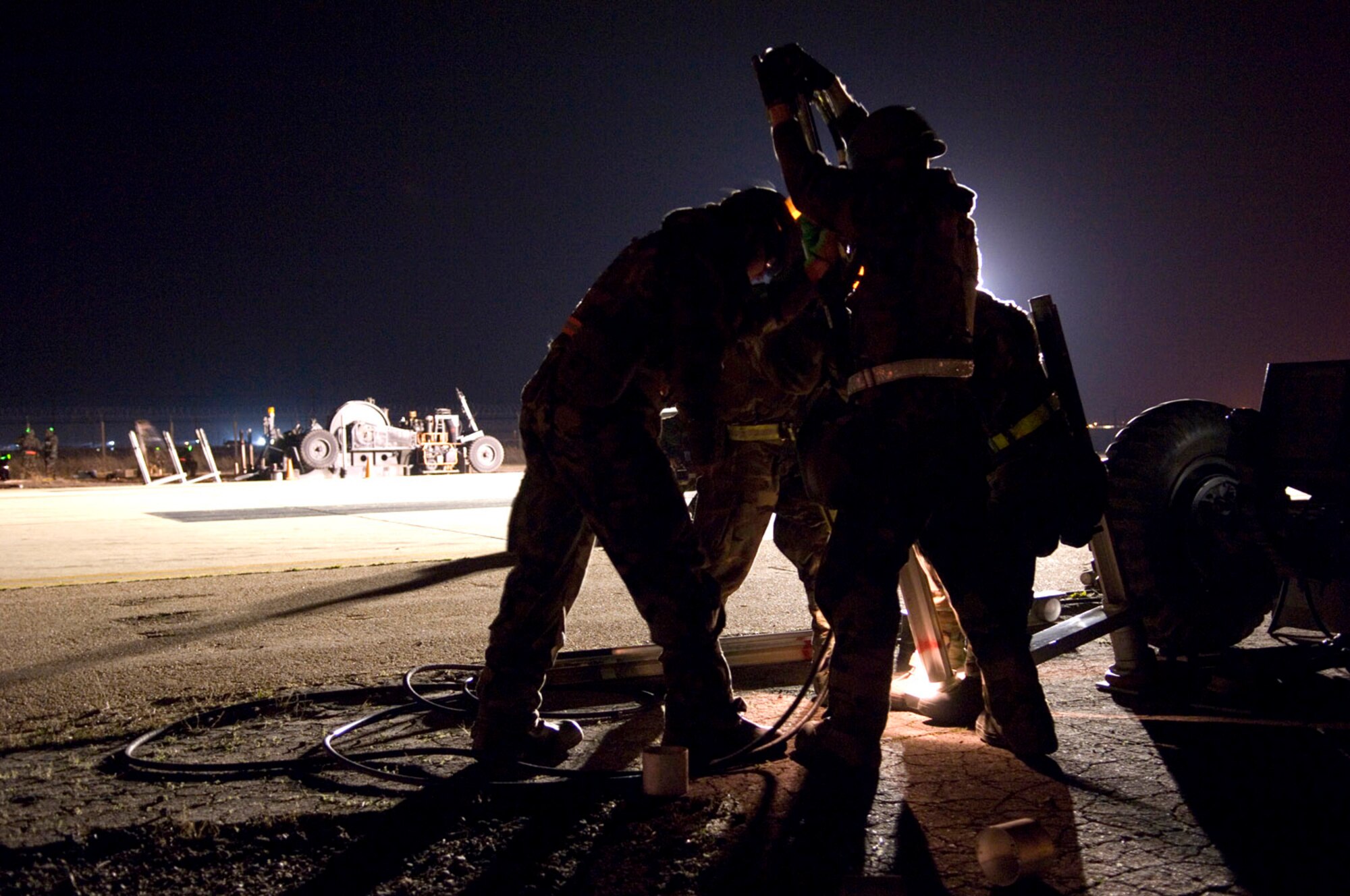 Members of the 8th Civil Engineer Squadron Airfield Damage Repair team install anchors in the Mobile Aircraft Arresting System April 19 at Kunsan Air Base, South Korea. The MAAS contains the cable used to stop damaged aircraft that cannot stop on their own during landing. Kunsan AB is currently undergoing an Operational Readiness Inspection to test the 8th Fighter Wing's ability to conduct its wartime mission. During exercises, ADR teams perform several functions including crater repair after simulated attacks and airfield lighting during simulated power outages, making it possible to get aircraft back in the air quickly. (U.S. Air Force photo/Master Sgt Jack Braden)