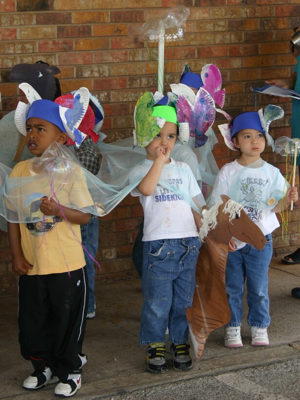 From left: Jayden Ali, Elijah Hart and Alison Stevens represent the "Commotion in the Ocean" portion of the Child Development Center's Month of the Military Child parade April 19. (U.S. Air Force photo/Staff Sgt. Tonnette Thompson)