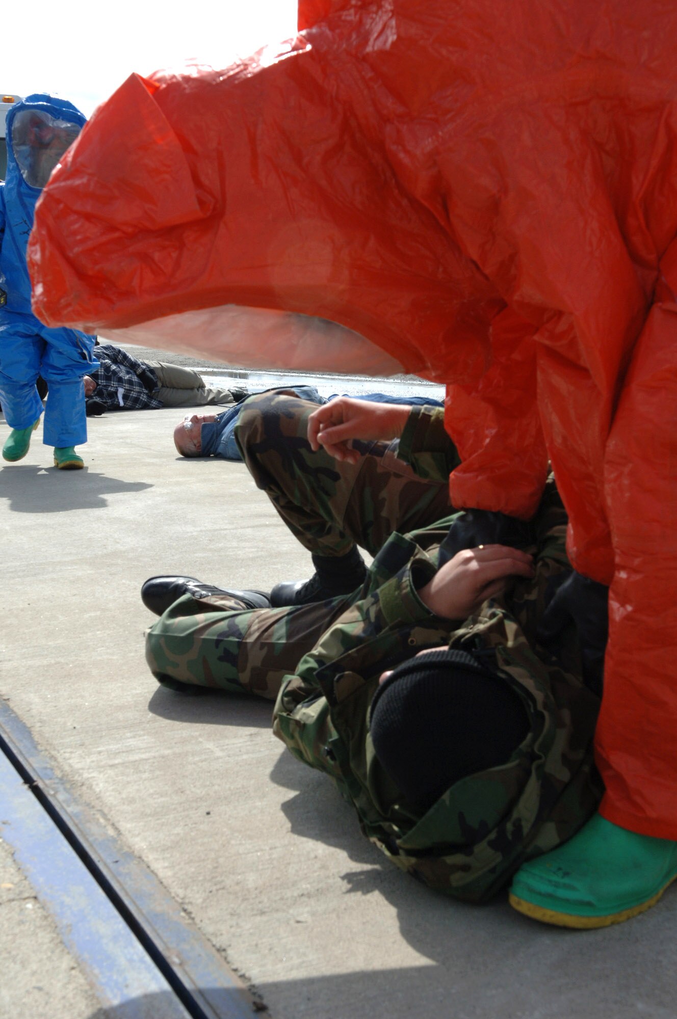 Senior Airman Kristopher Doughty checks on a simulated injured Airman April 19 during an exercise at Fairchild Air Force Base, Wash. The intent of the exercise is to test base personnel's abilities to respond to a weapon of mass destruction. Airman Doughty is assigned to the 92nd Civil Engineer Squadron. (U.S. Air Force photo/Airman 1st Class Jocelyn Ford) 