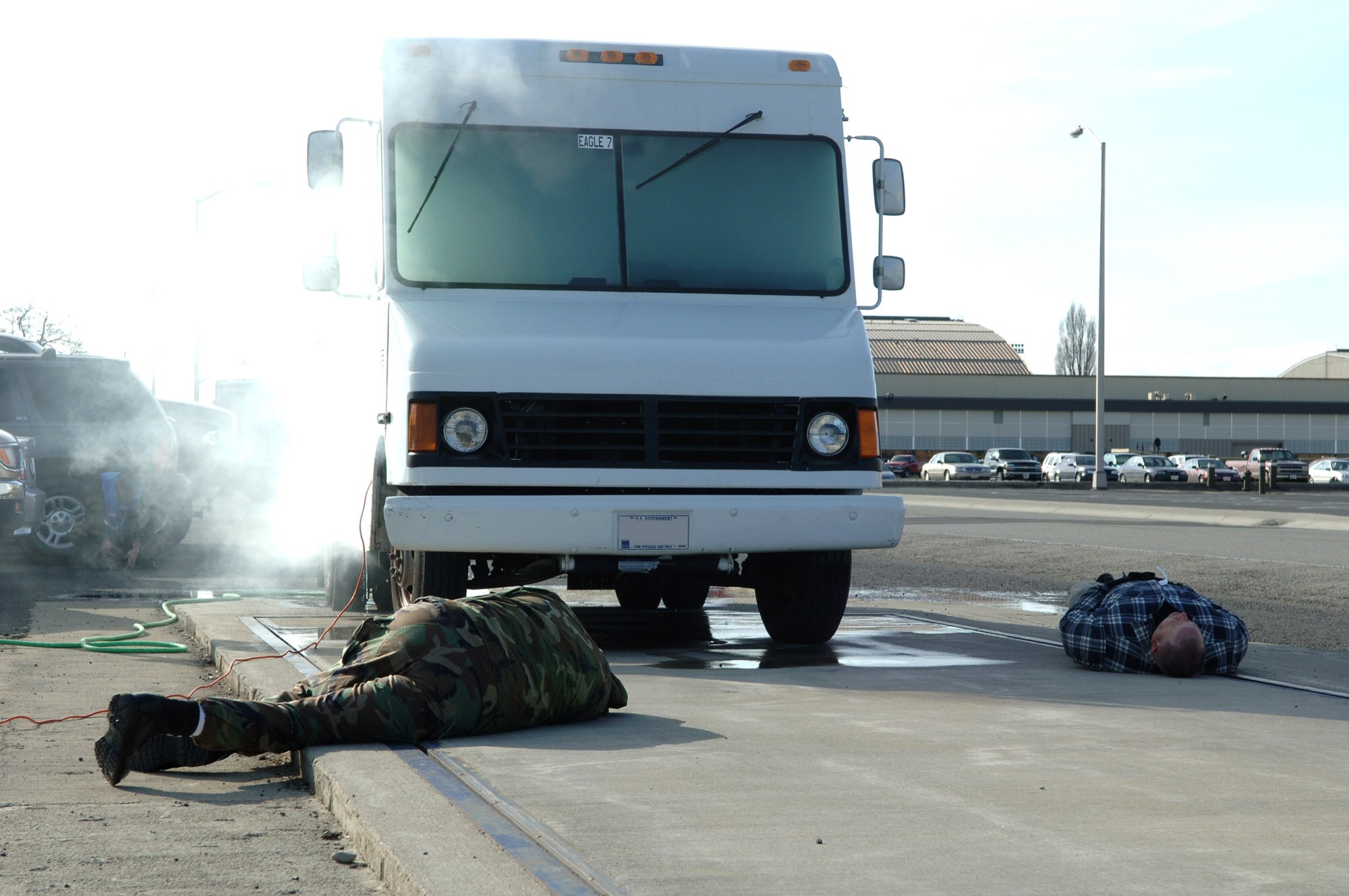 Two simulated victims lay on a truck scale April 19 after inhaling fumes coming from a punctured tank of gas during an exercise held at Fairchild Air Force Base, Wash. The fumes were simulated chlorine to test the base's ability to respond to a weapon of mass destruction. (U.S. Air Force photo illustration/Airman 1st Class Jocelyn Ford)