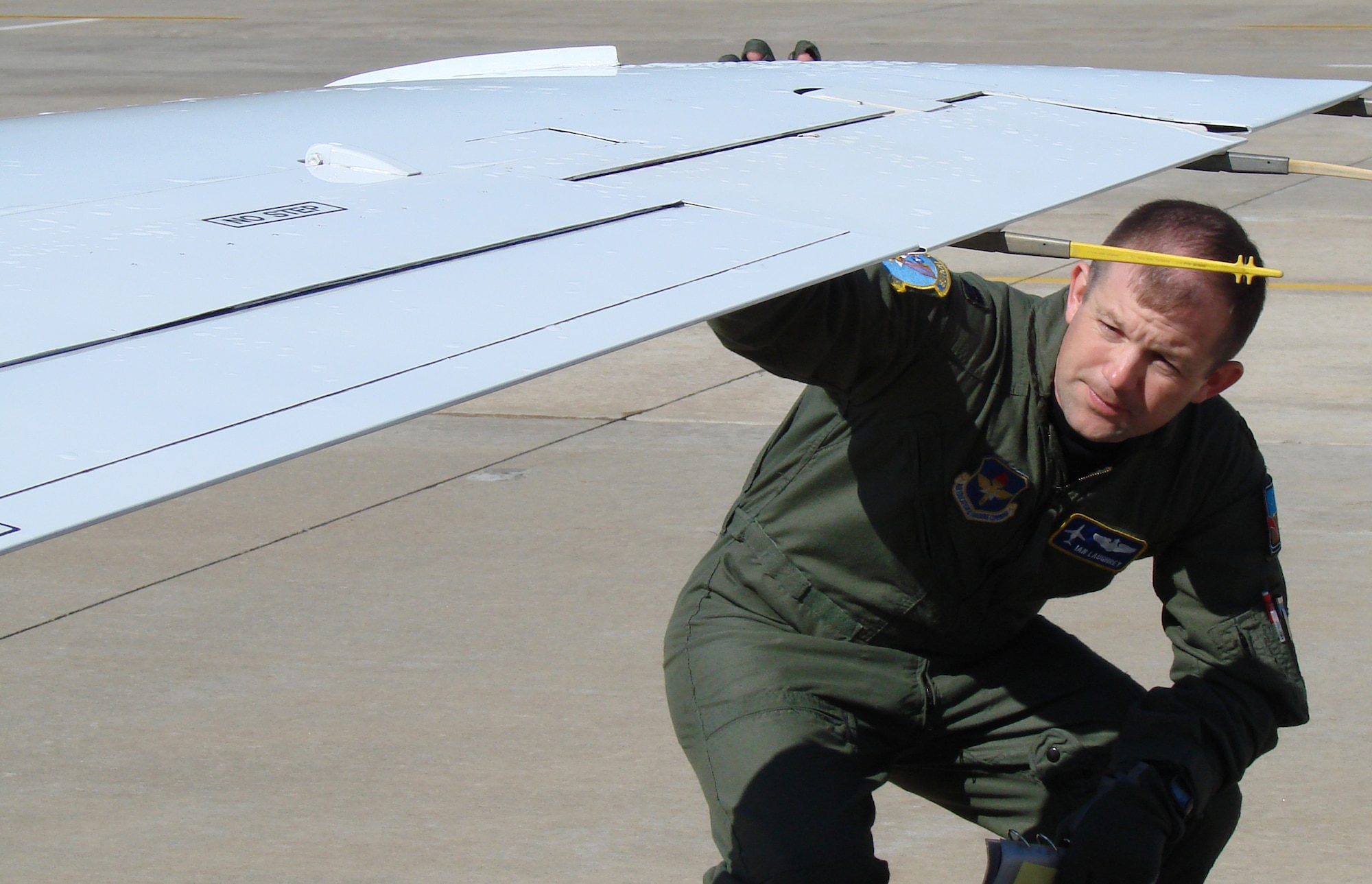 Capt. Ian Laughrey, 32nd Flying Training Squadron check flight commander, performs a preflight check before a T-1 mission from Vance Air Force Base. Captain Laughrey leaves Vance in September for an assignment with the 89th Airlift Wing, Andrews AFB, Md., where he will fly a C-40 transporting the nation’s civilian and military leaders to locations around the globe. (U.S. Air Force photo by 2nd Lt. James Justice) 