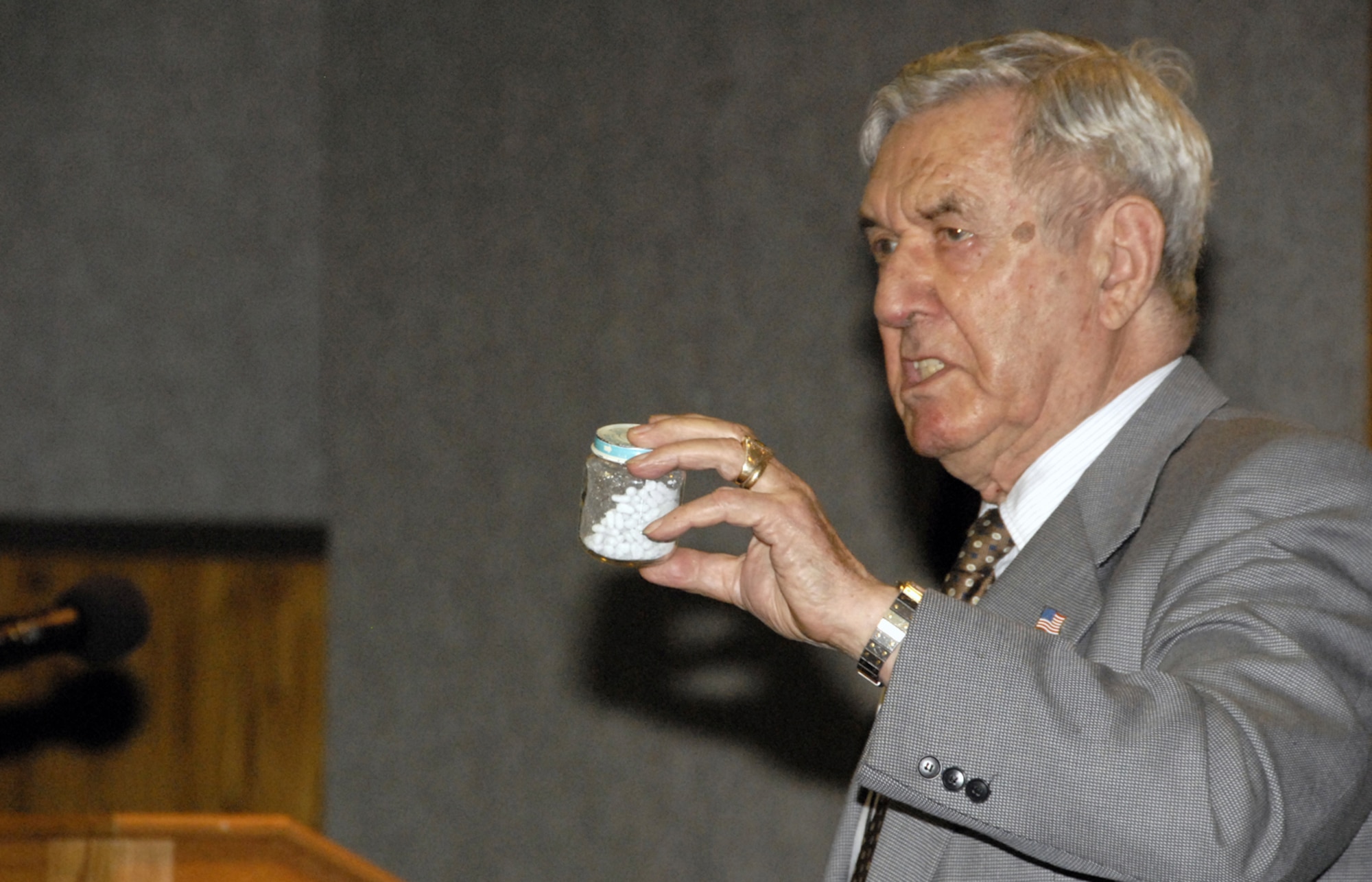 Michael Jacobs, a Holocaust survivor, shows attendees of the April 17 Sheppard Air Force Base Holocaust Rememberance Luncheon cyanide tablets similar to those used in the Nazi concentration camps. (U.S. Air Force photo/Sandy Wassenmiller)