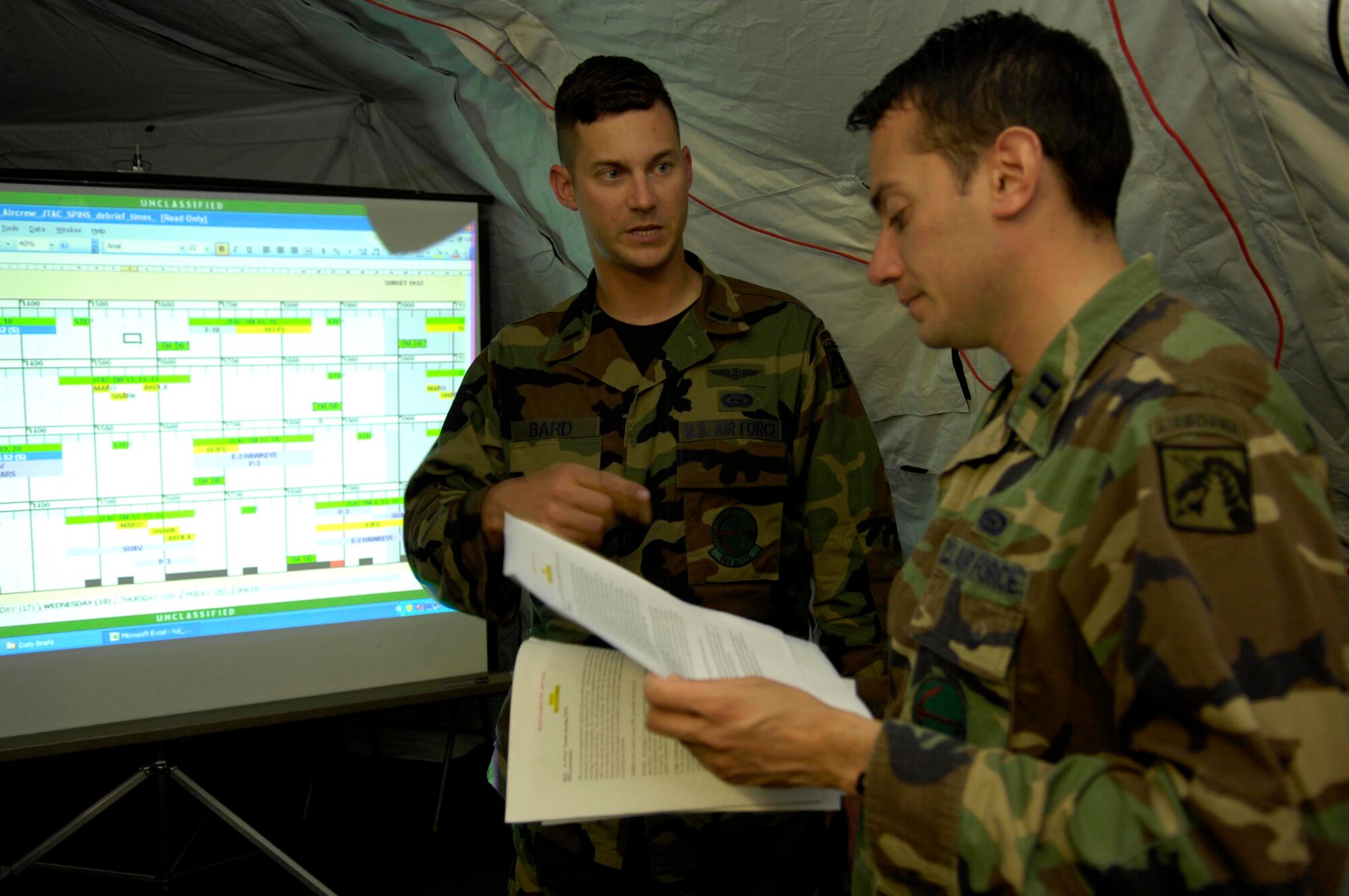 First Lt. Brandon Bard speaks with Capt. Eric Nunez April 18 about ways to increase mission efficiency during Atlantic Strike V. Atlantic Strike is a semi-annual joint forces training event involving Joint Terminal Attack Controllers from the Air Force, Army and Marines. The event is held at Avon Park Air Ground training Complex in Avon Park, Fla. (U.S. Air Force photo by Staff Sgt. Stephen J. Otero)