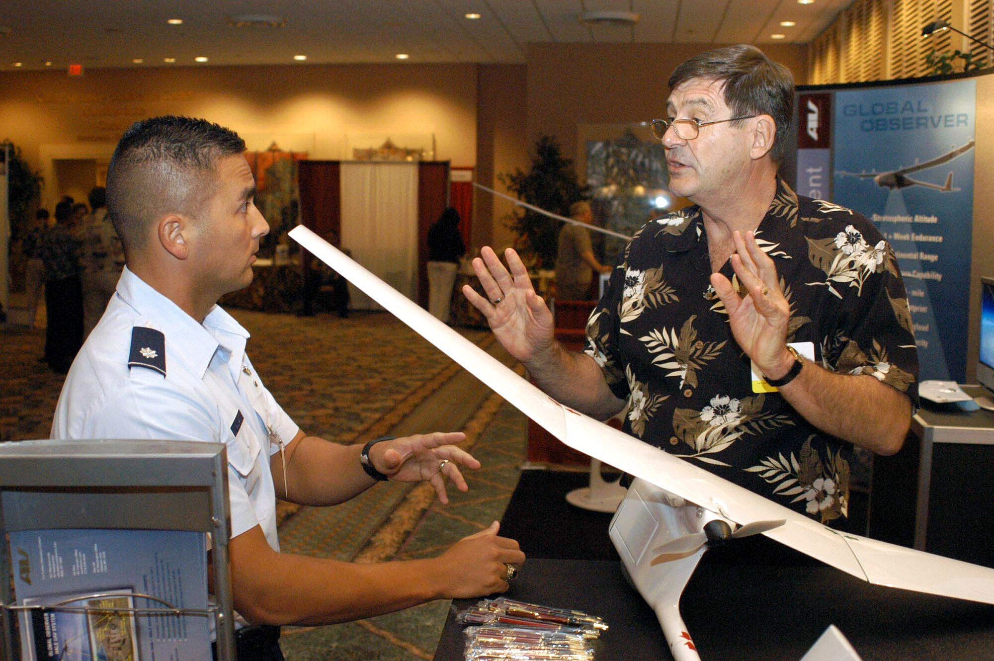Lt. Col. Chris Sullivan discusses the Raven unmanned aerial vehicle with Ted Wierzbanowski of AeroVironment at the Pacific Operational Science and Technology Conference and Exhibition April 3. Colonel Sullivan is a contingency planner for 13th Air Force from Hickam Air Force Base, Hawaii. (U.S. Air Force photo/Staff Sgt. Tim Meyer)
