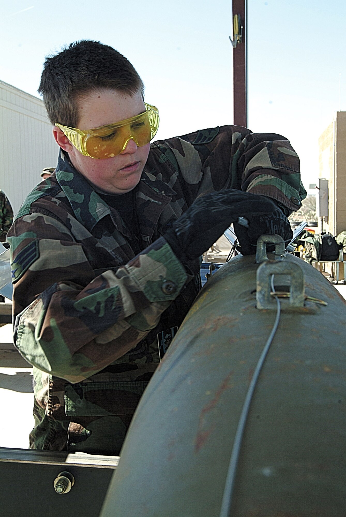 Senior Airman Stephanie Couch, a munitions systems technician, works on a 500-pound Mark 82 bomb at the Davis-Monthan Air Force Base, Ariz., munitions storage area. Couch and fellow ammo Airmen provided a steady flow of bombs for the Wing's pilots to drop at the range. Airman Crouch is assigned to the 442nd Maintenance Squadron deployed from Whiteman Air Force Base, Mo. (U.S. Air Force photo/Master Sgt. William Huntington)