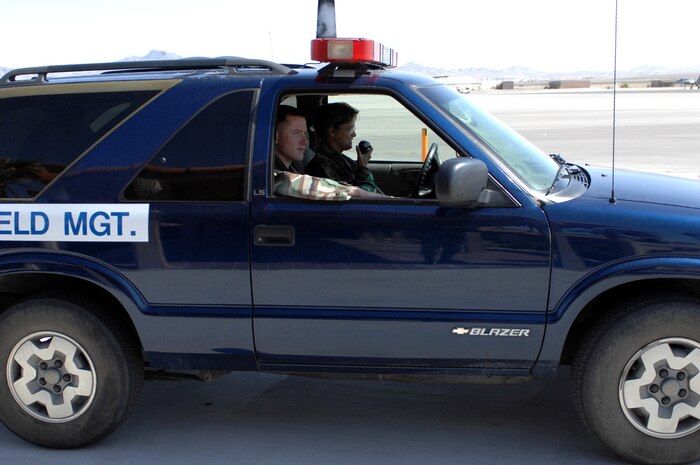 Staff Sgt. Ann Brooks and Airman 1st Class Sean Moffit, 57th Operations Support Squadron, Airfield Management Office, drive around checking for flightline trash, more commonly known as FOD on airfields, and respond to emergencies.   (U.S. Air ForcePhoto by Senior Airman Jason Huddleston.)