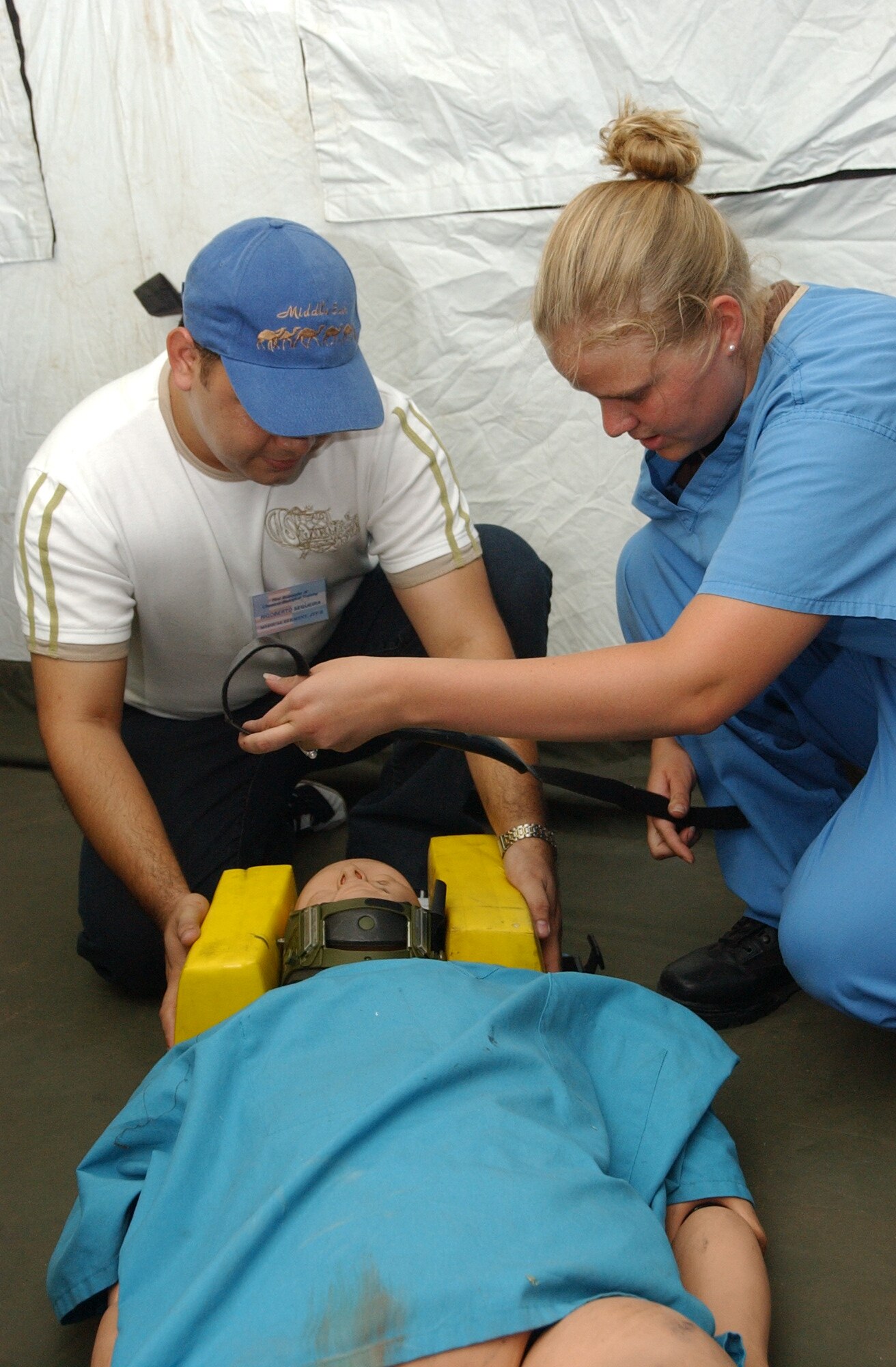 SOTO CANO AIR BASE, Honduras -- Senior Airman Jessica Laws, Medical Element, explains to a student how to stabilize a patient with a possible neck or spinal cord injury, during a major accident response exercise.  Thirty eight students attended the class, which provided training, focusing mainly on first aid techniques, and chemical, biological, radiological, nuclear, and explosive (CBRNE) readiness training, including how to don the chemical protection suit.  (U.S. Air Force photo/Tech. Sgt. Sonny Cohrs)