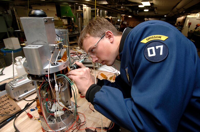 Senior cadet Harrison Sumerall performs the last electrical test on the Falcon Launch-5 avionics case April 12 at the U.S. Air Force Academy in Colorado Springs, Colo. The satellite is being designed and built by Academy cadets. It will be tested and operated by the cadets through the USAFA Space Systems Research Center. (U.S. Air Force photo/Mike Kaplan)