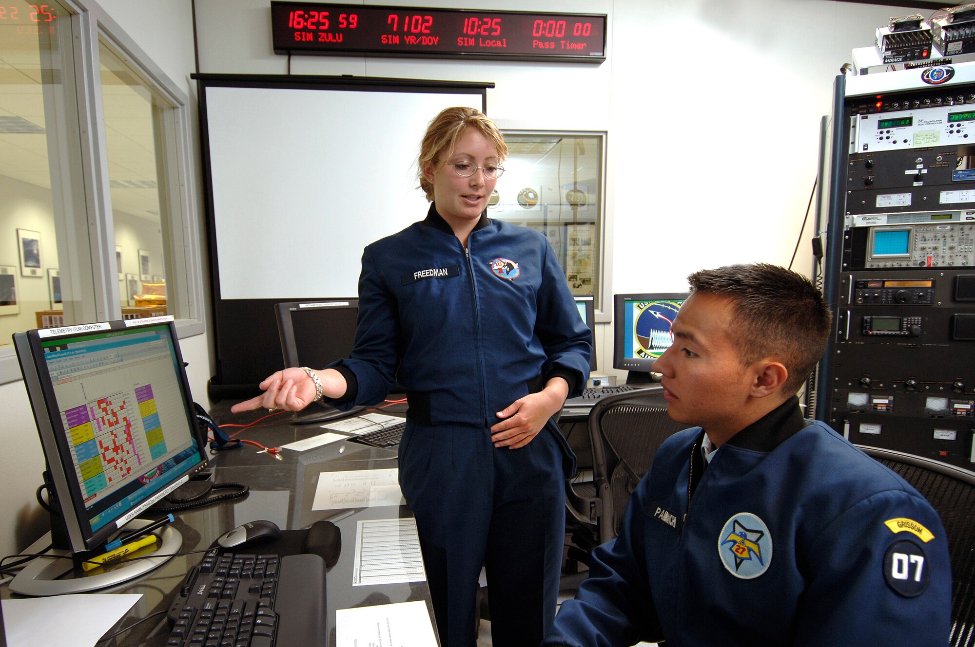 Cadet senior Charlette Freedman explains to cadet commander senior Johann Pambianchi April 12 when the next Falcon Satellite-3 pass will occur at the U.S. Air Force Academy in Colorado Springs, Colo. Based on orbital mechanics of the satellite which launched in March from Cape Canaveral Air Force Station, Fla., a pass occurs three or four times per day. The satellite was designed and built, by Academy cadets who now test and operate it. The project is administered by the USAFA Space Systems Research Center. (U.S. Air Force photo/Mike Kaplan) 

