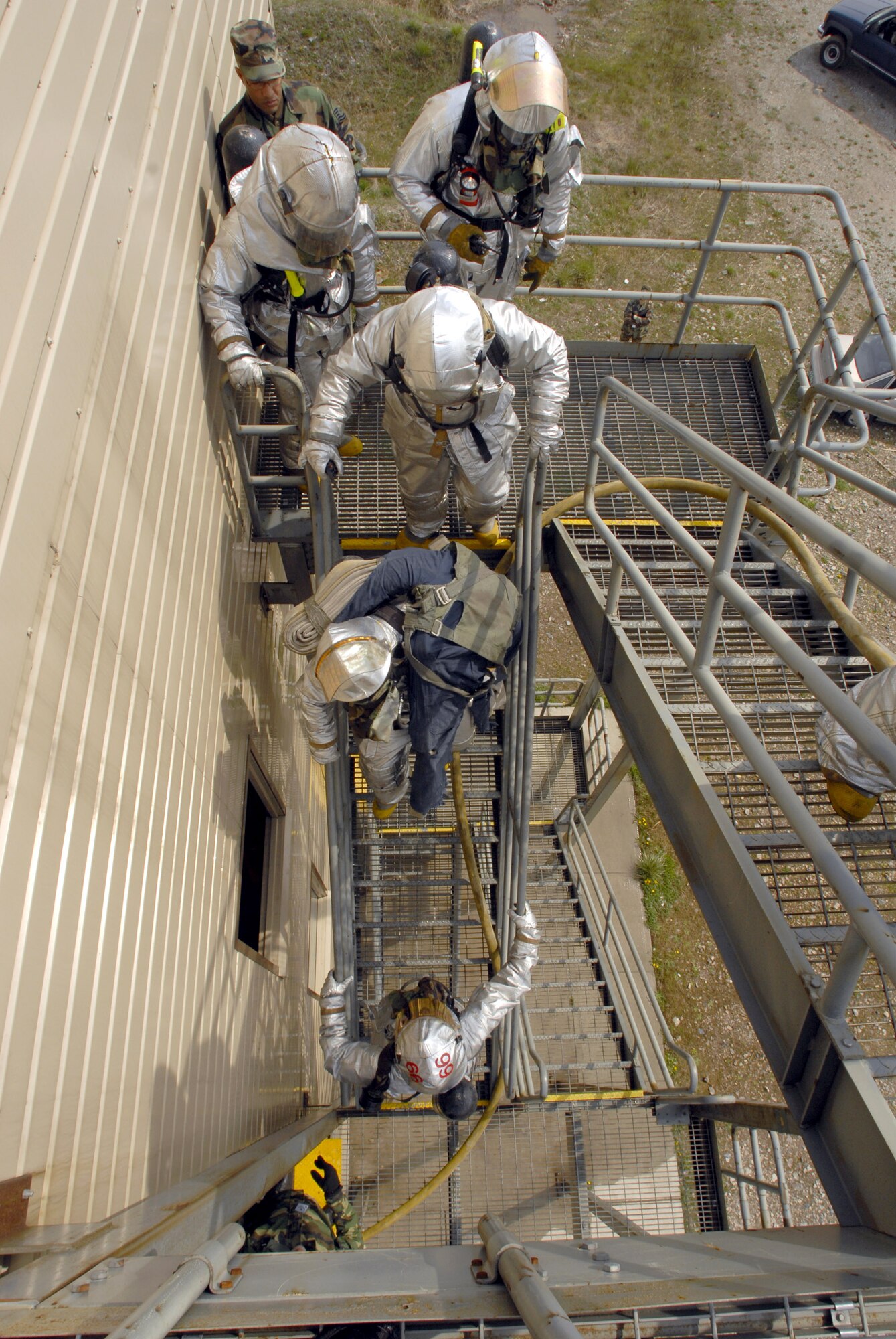 Firefighters from the 8th Civil Engineer Squadron climb stairs to respond to a simulated fire during an operational readiness inspection April 17 at Kunsan Air Base, South Korea. Kunsan AB is currently undergoing an operational readiness inspection to test the 8th Fighter Wing's ability to conduct its wartime mission. (U.S. Air Force photo/Senior Airman Barry Loo) 
